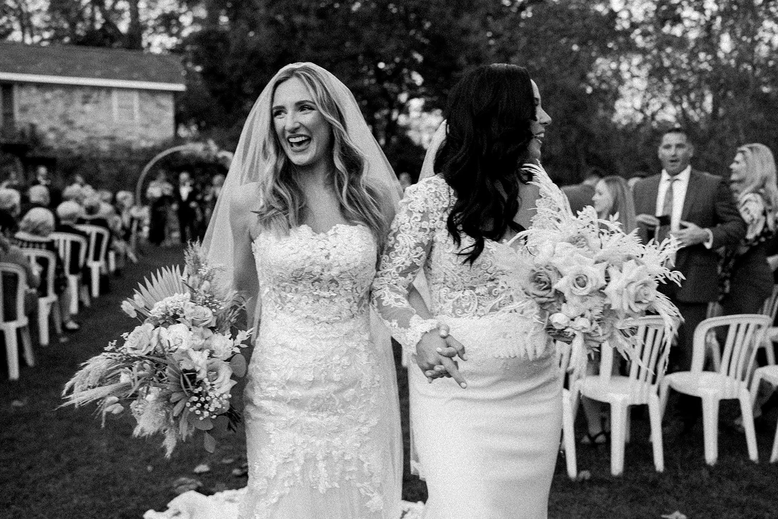 Kamp weddings couple lauren and alexis embracing on their wedding day.