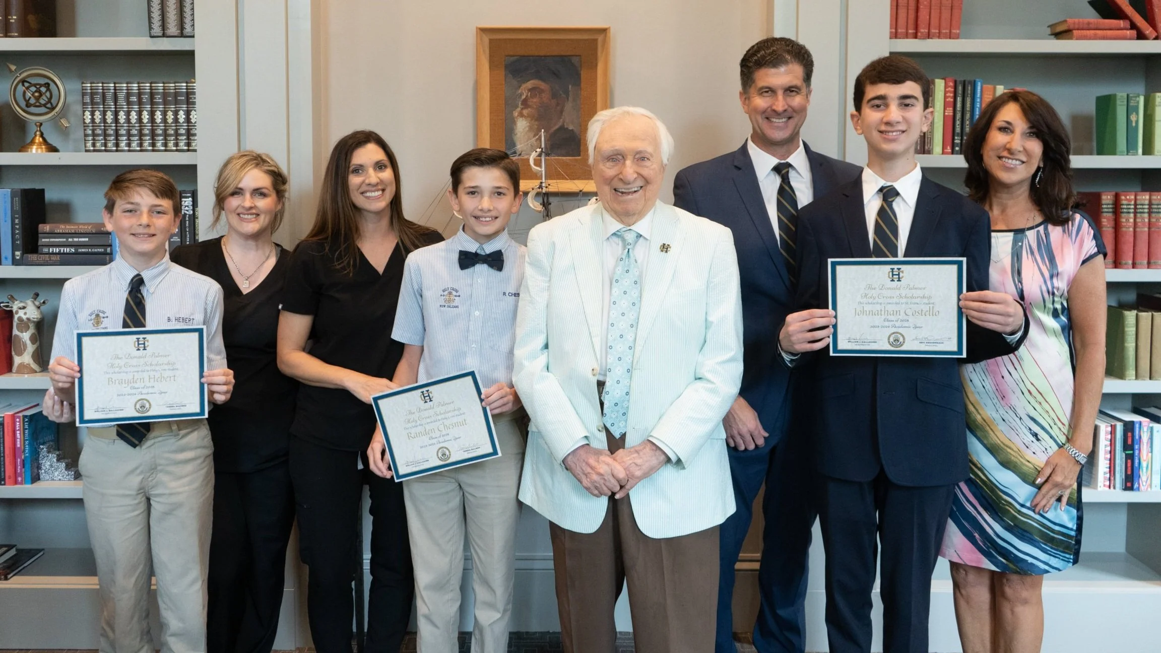 A scholarship recipient and his family and Donald Palmer from Holy Cross School in New Orleans