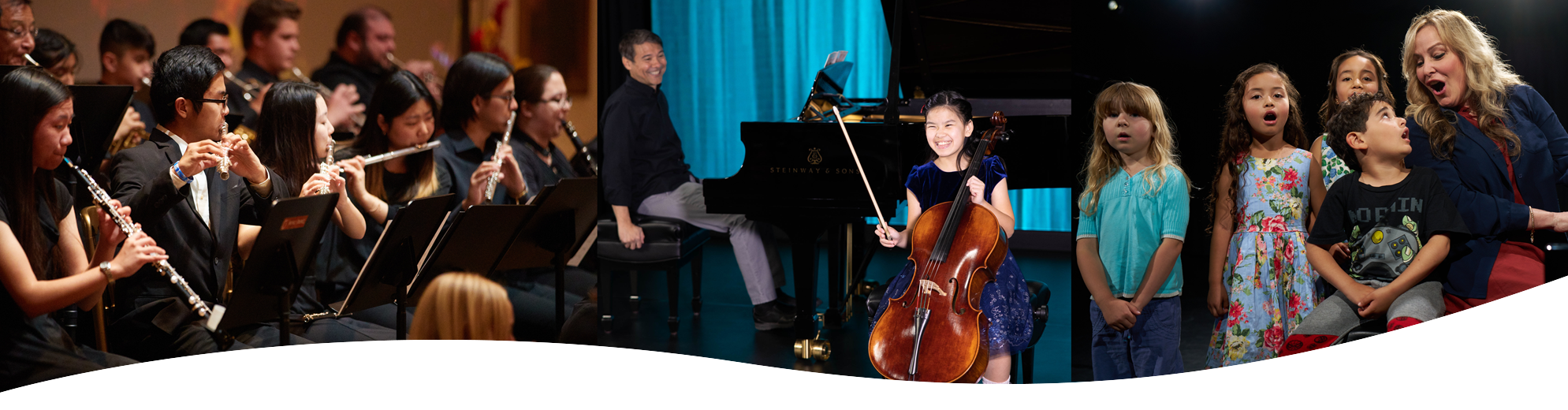 Violinist smiling on stage with pianist in background