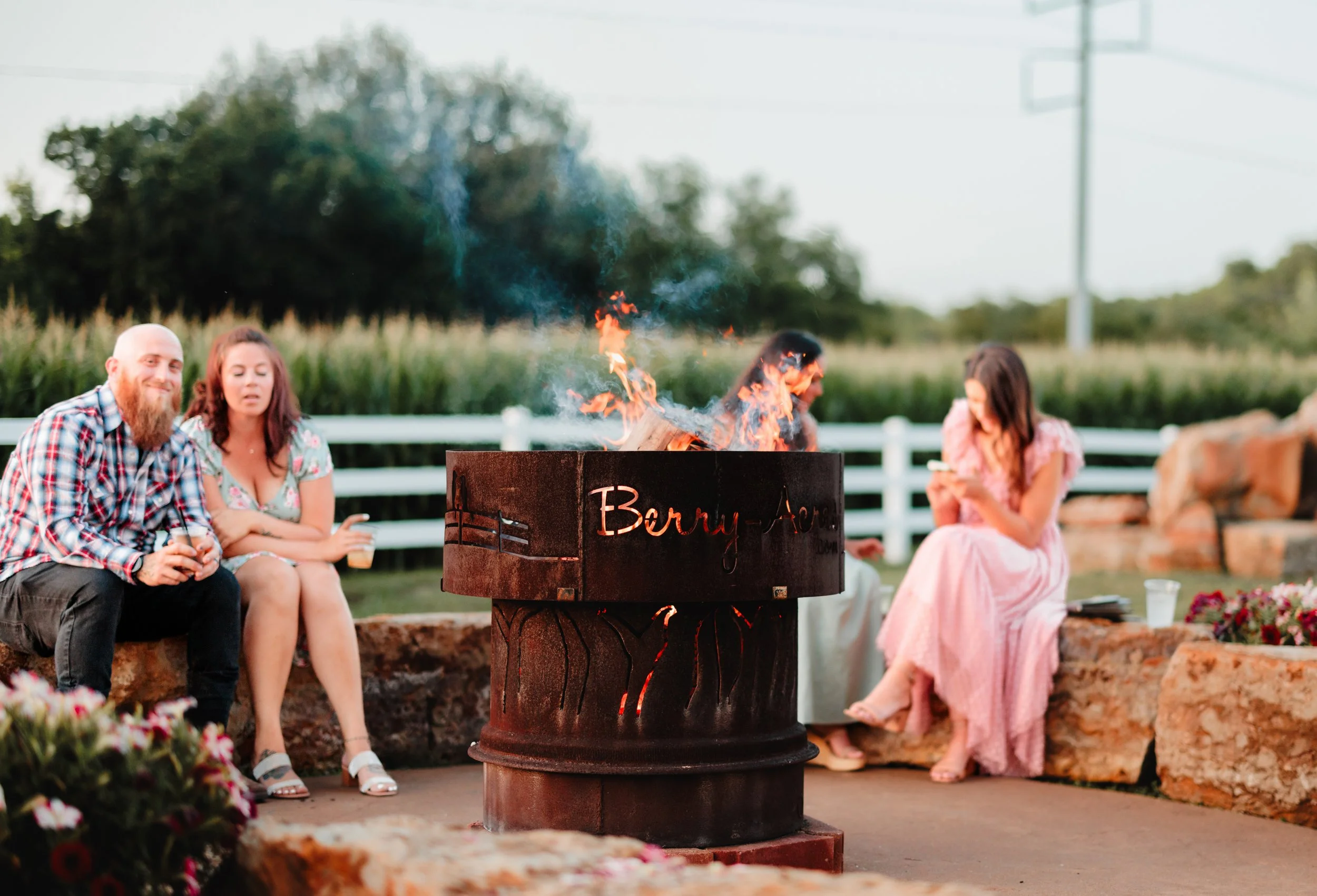 kansas city wedding photographer capturing candid moments around the firepit at Berry Acres wedding and event venue