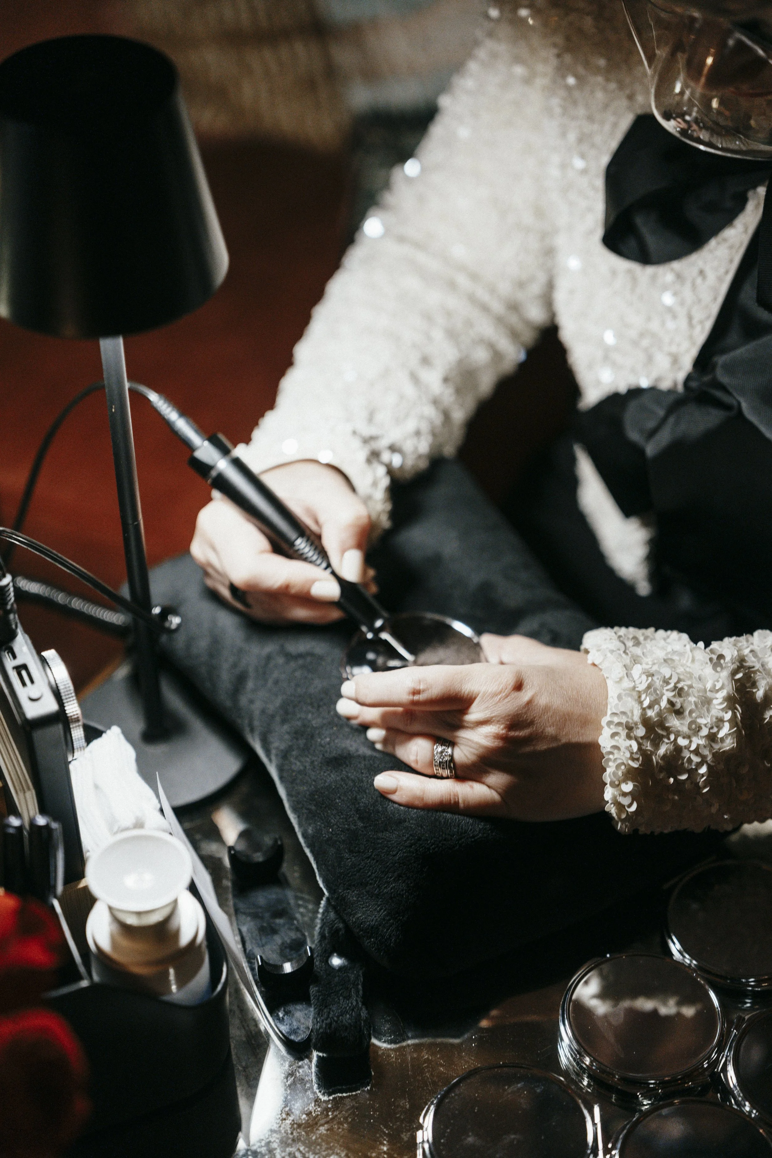 Live event engraving on compacts, close up of hands.