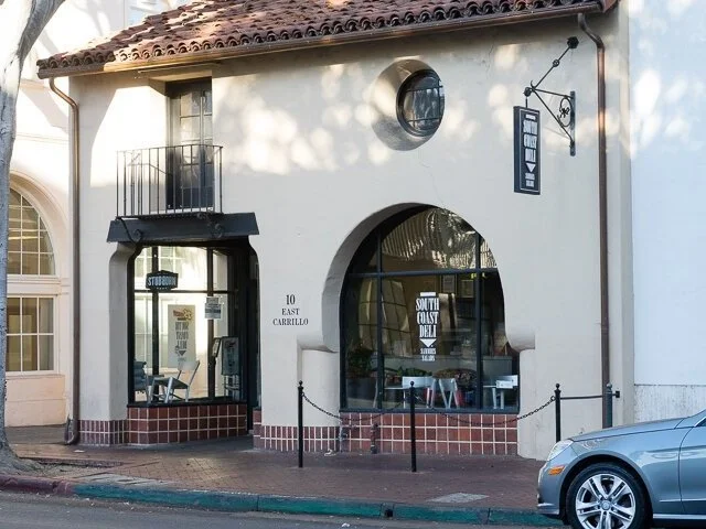 Exterior of South Coast Deli at 10 East Carrillo Street in downtown Santa Barbara, housed in a classic Spanish Colonial building