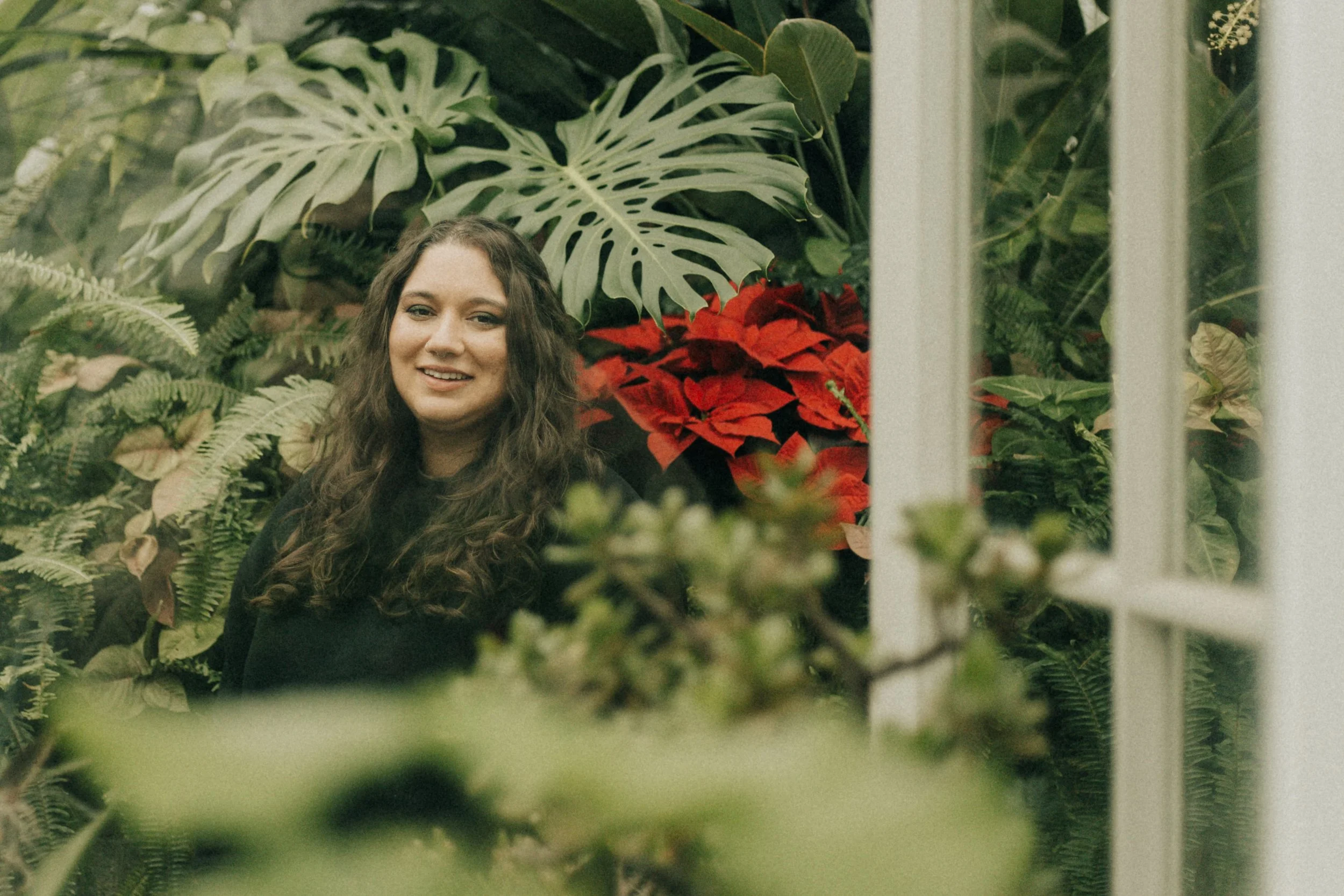 Owner Charlotte in a greenhouse