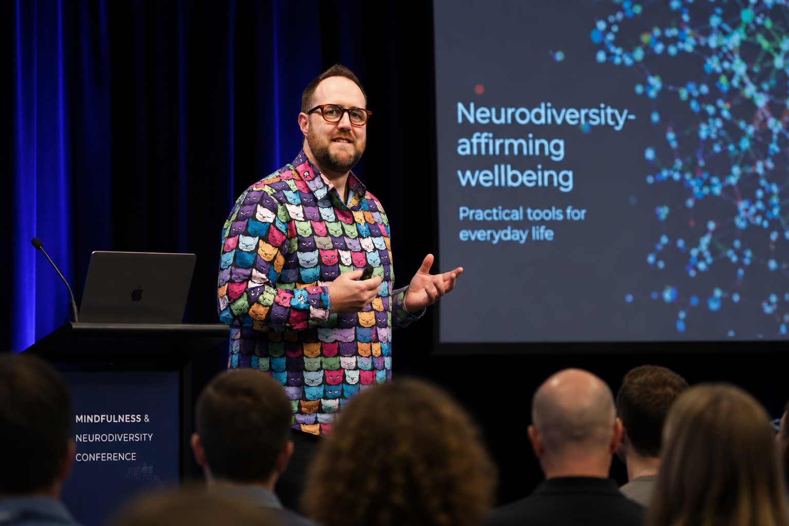 Daniel Wright delivering an engaging keynote presentation on neurodiversity-affirming wellbeing, mindfulness, ADHD, burnout prevention and mental health strategies for workplaces, schools and healthcare professionals.
