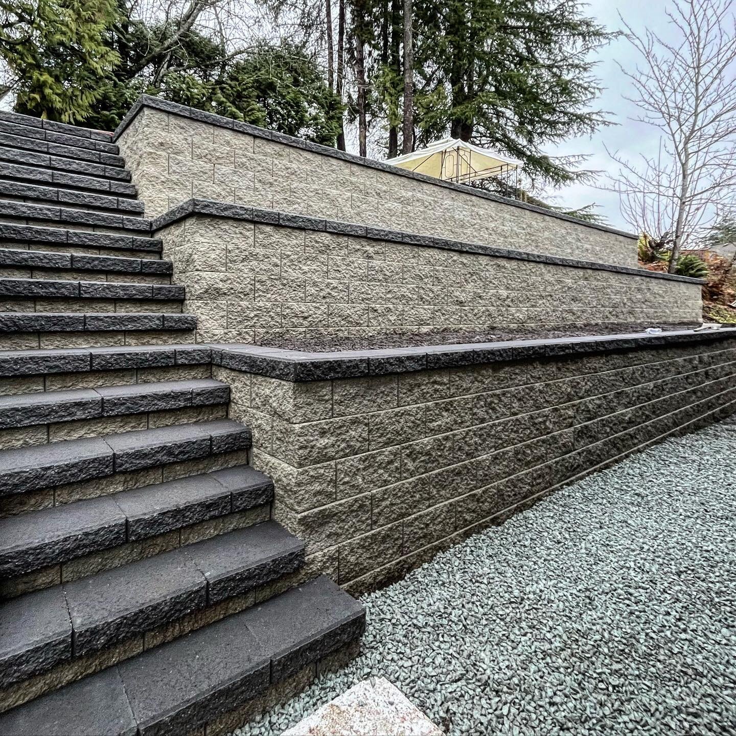 Brand new three-tiered retaining walls installed in only 5 days! Swipe ➡️ to see before and afters! We work year round and rain or shine. #mountainscape #hardscape #howtohardscape #pavingstones #retainingwalls #landscape #pnw #vancouver #northshore #