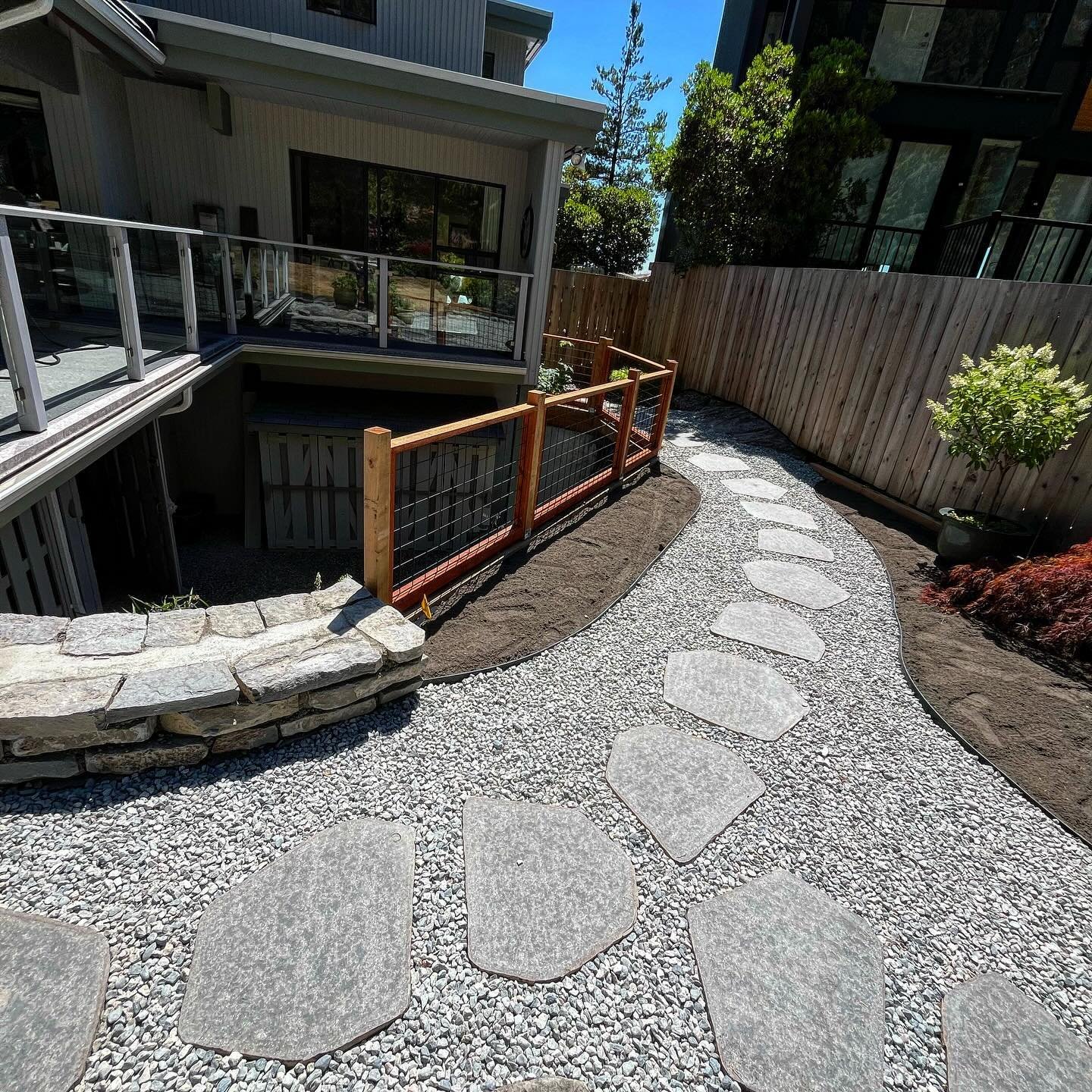 Swipe ➡️ to see a big transformation! We opened up this cramped backyard, removed a rotten deck and turned the space into a useable yard for our clients. Natural basalt stepping stone and wall stone supplied from @creativebricksnblocks #hardscape #ho