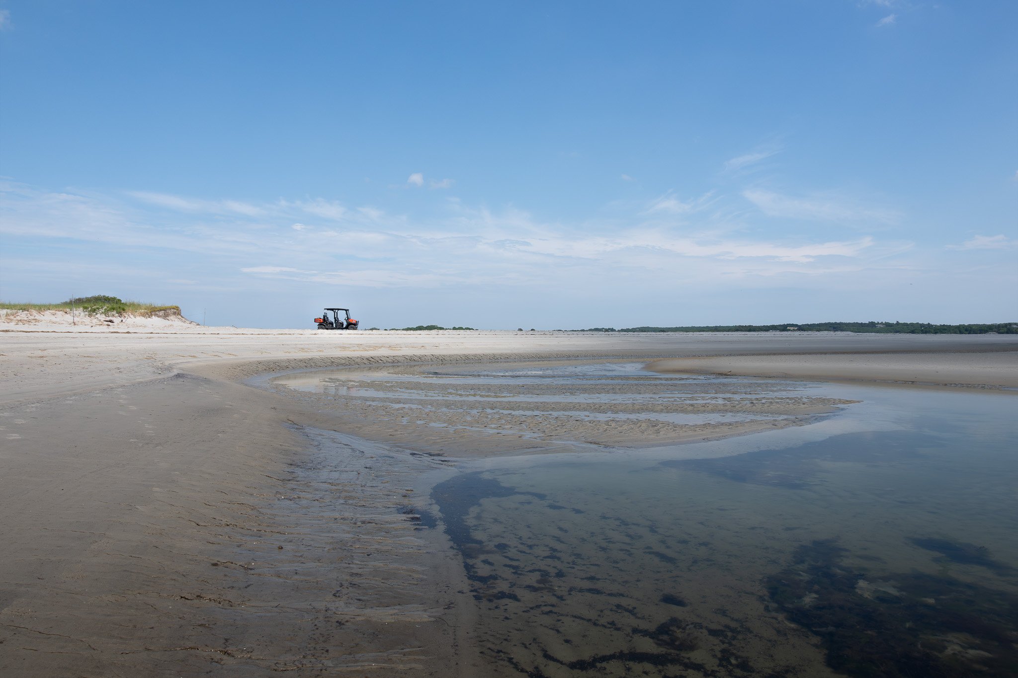 The expansive intertidal and a scientific survey vehicle for scale.