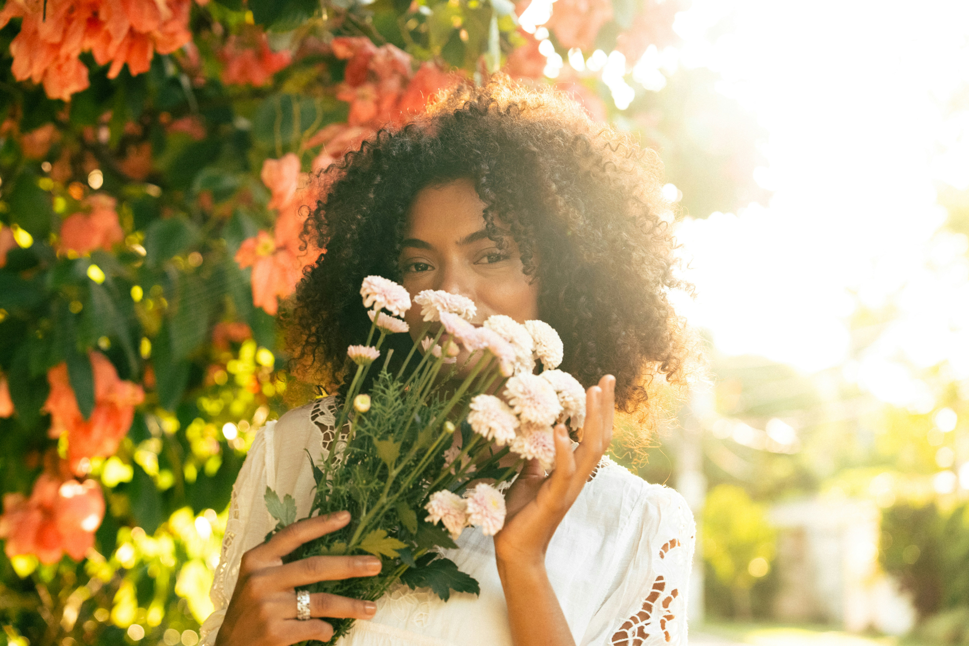 A photo of a woman in the spring, holding a bouquet of flowers