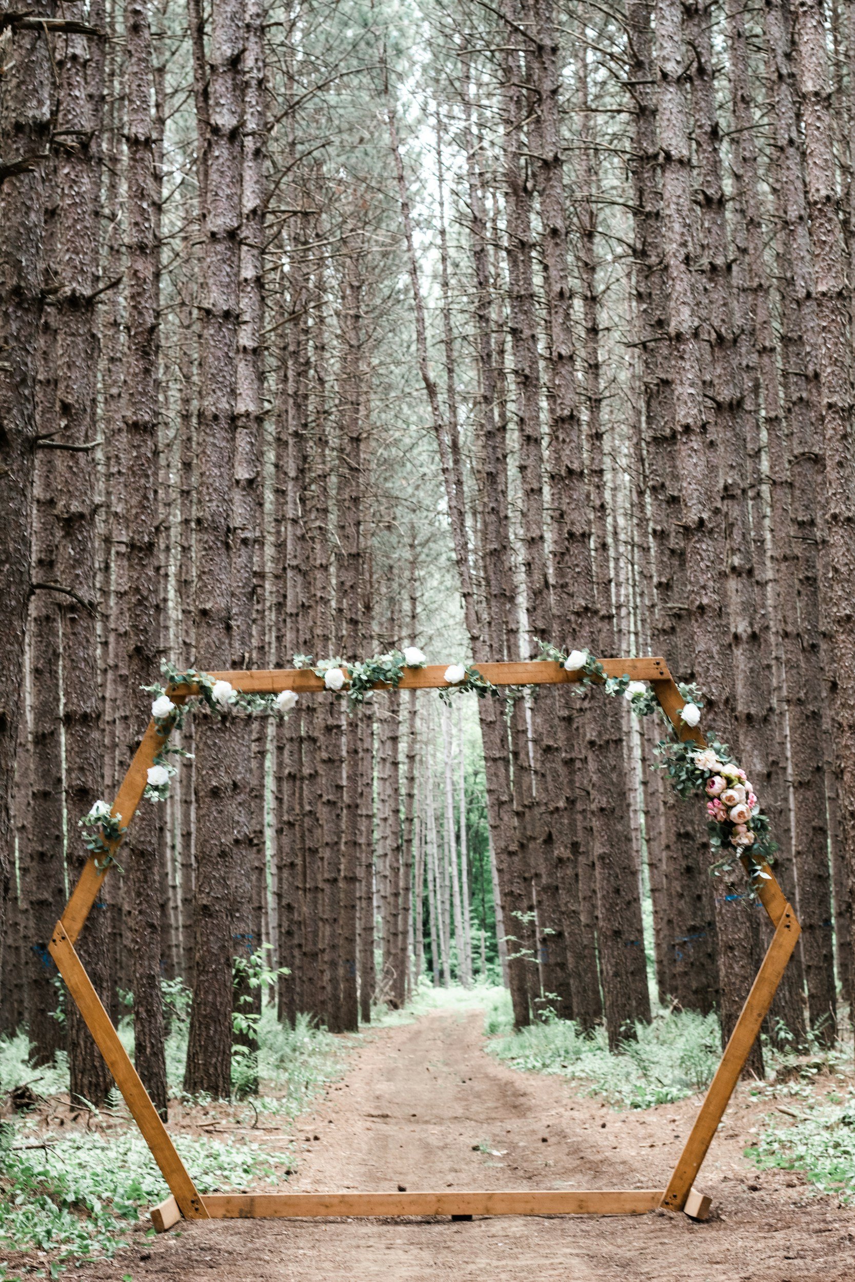 Decorative wooden arch in wooded forest