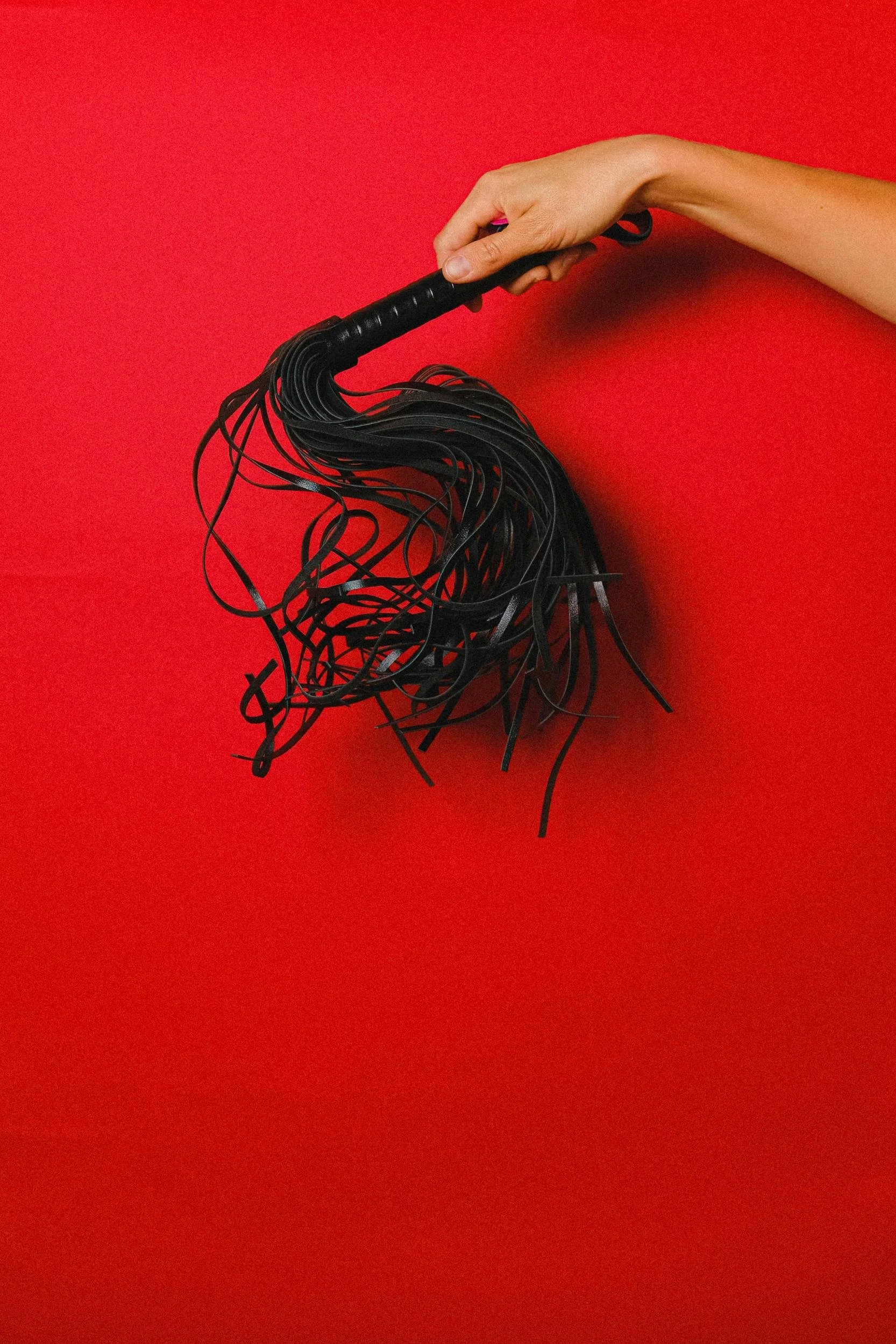 Red background with flogger