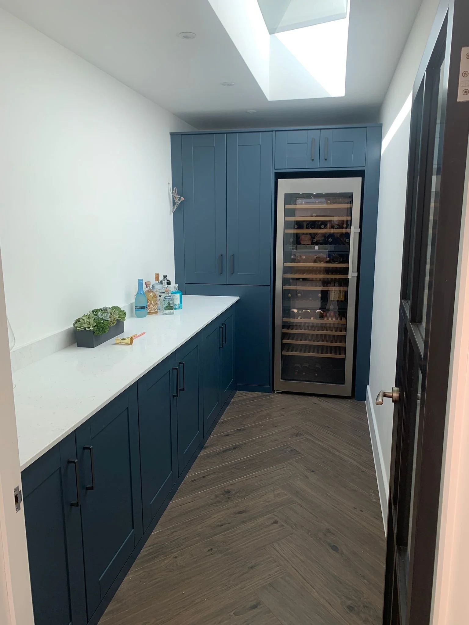Luxury Utility Room with Fitted Cabinets and Wine Storage.jpeg