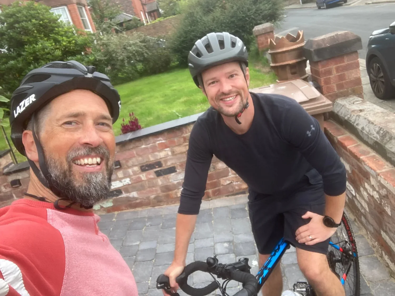 James Chapman and James Burch in cycling helmets, smiling at the camera