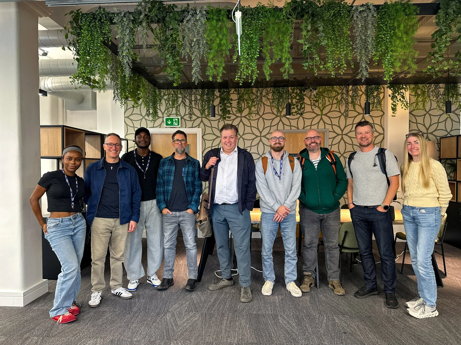 Nine members of the Melo team standing together in the office