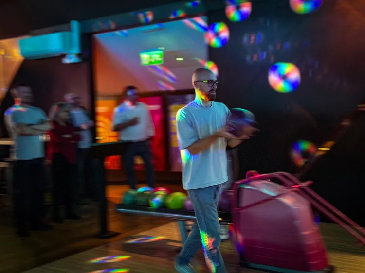 A team member about to bowl at a team night out