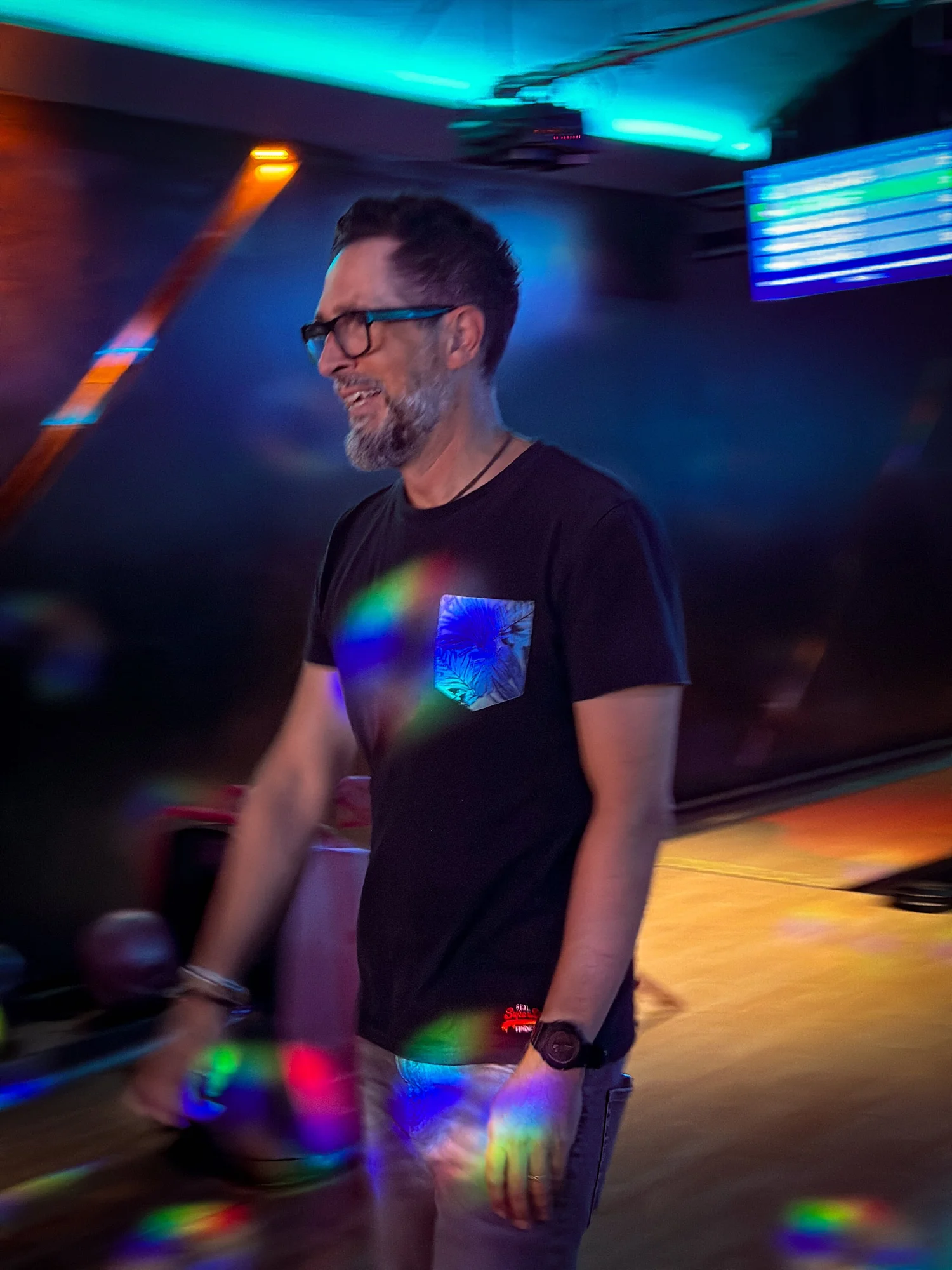 A team member laughing at a team bowling night
