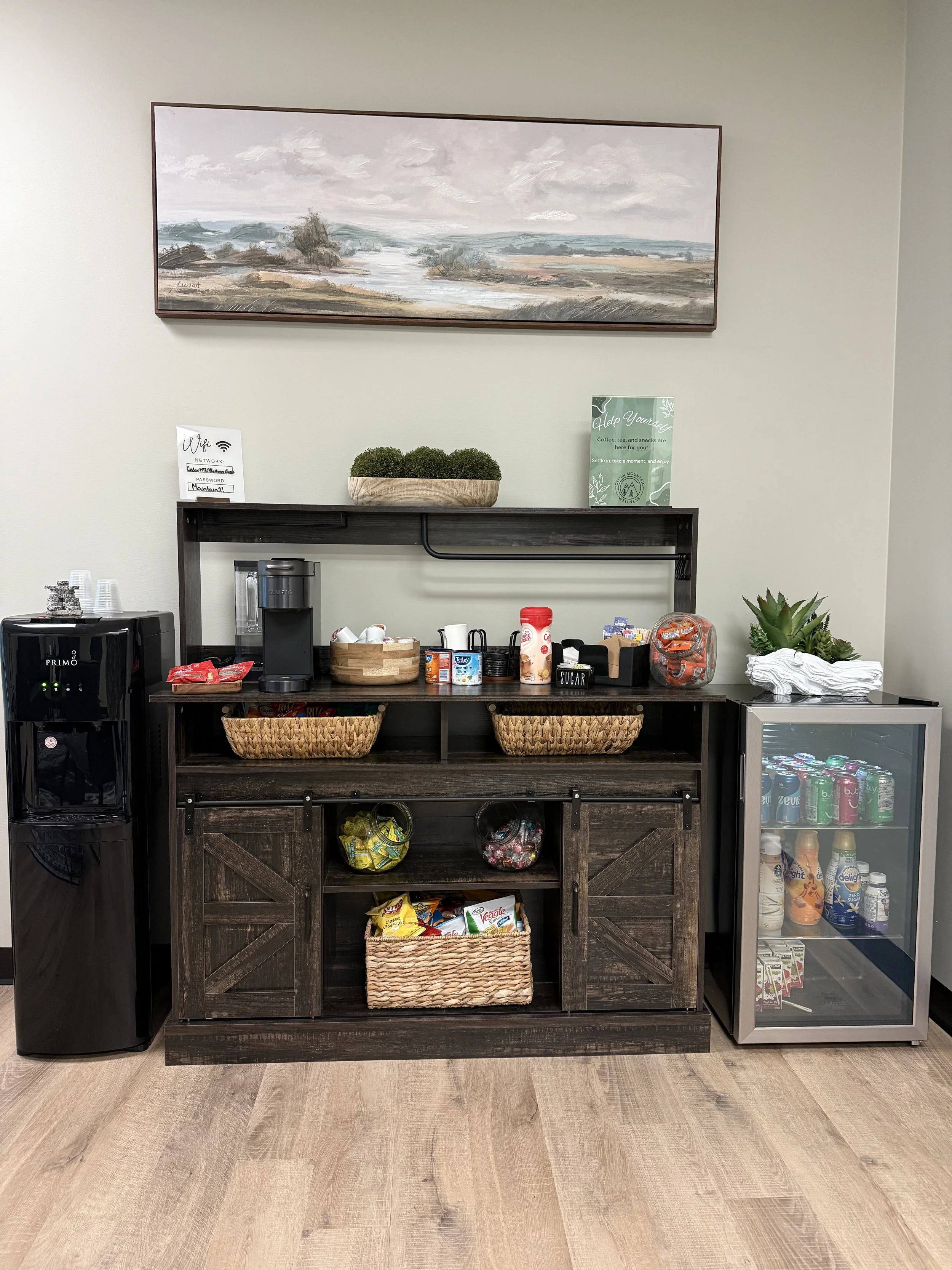 Winnipeg counselling office beverage station at Cedar Mountain Counselling, featuring coffee, tea, snacks, and a mini fridge for client comfort.