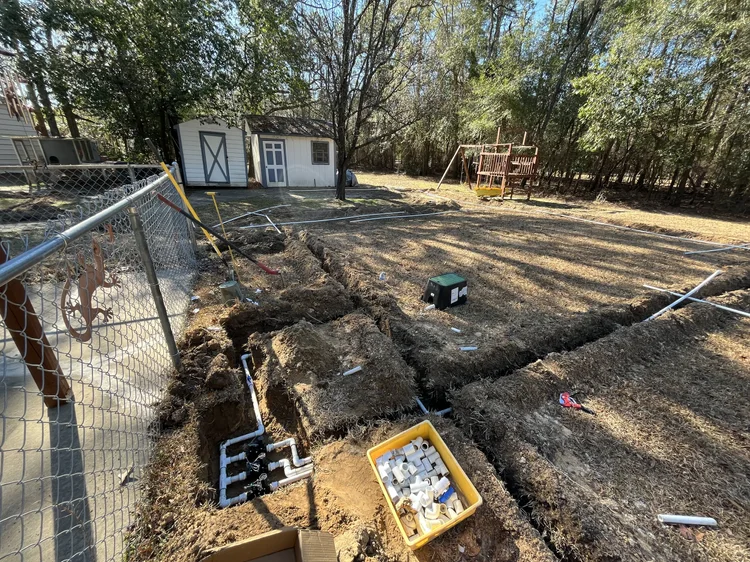 Overhead view of trenches and valve boxes at a job site