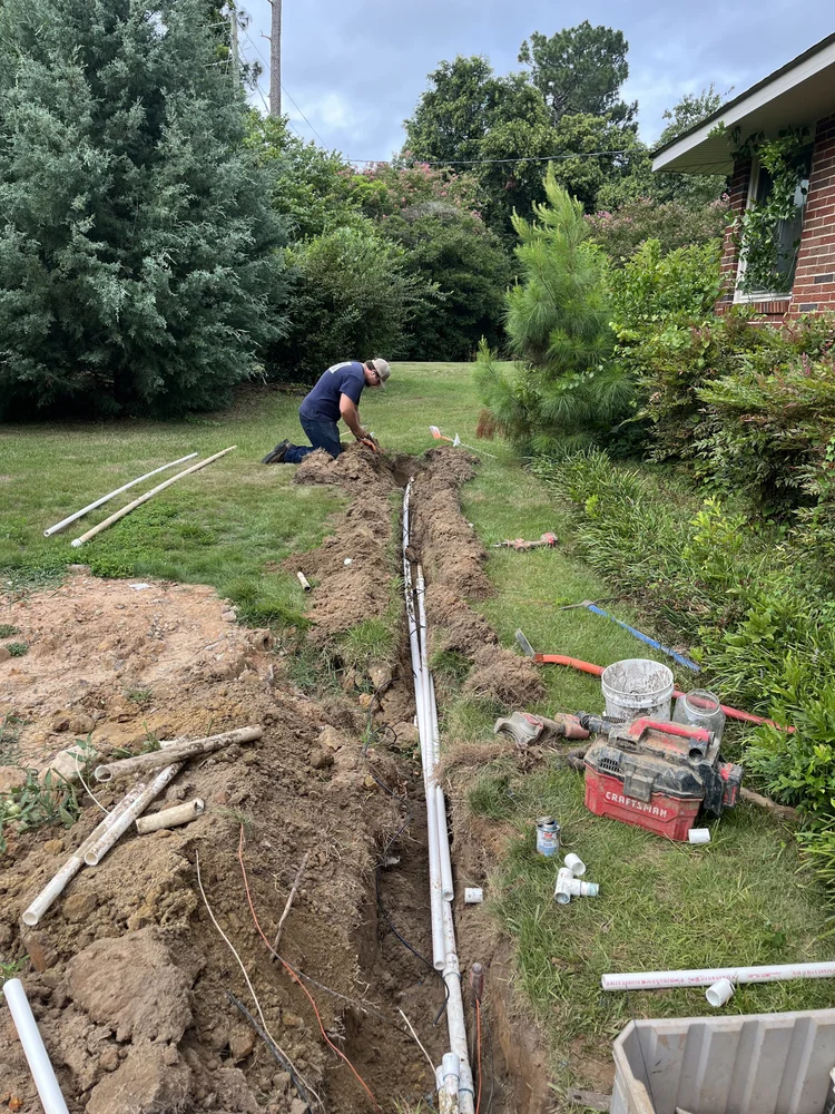 Pipe being laid in a trench along a property line