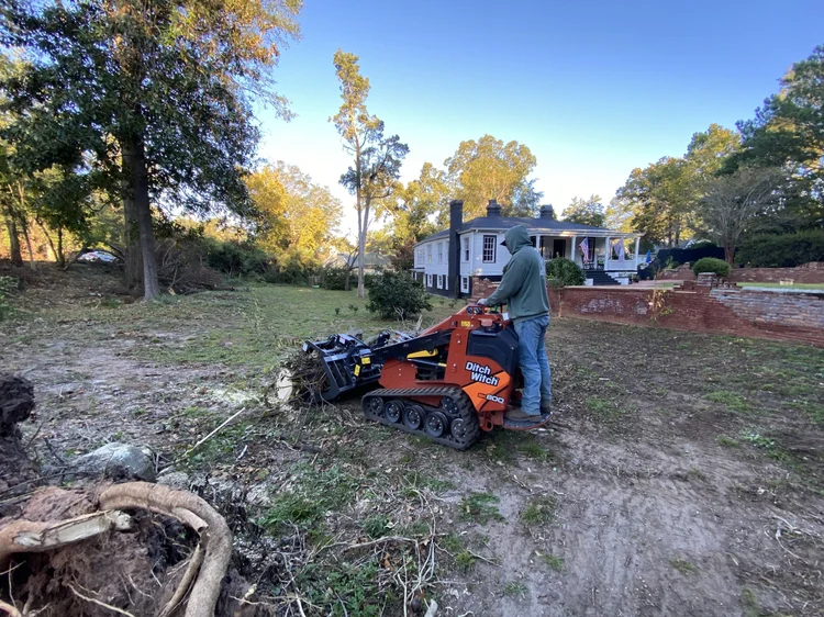 Mini skid steer trenching for a new irrigation system