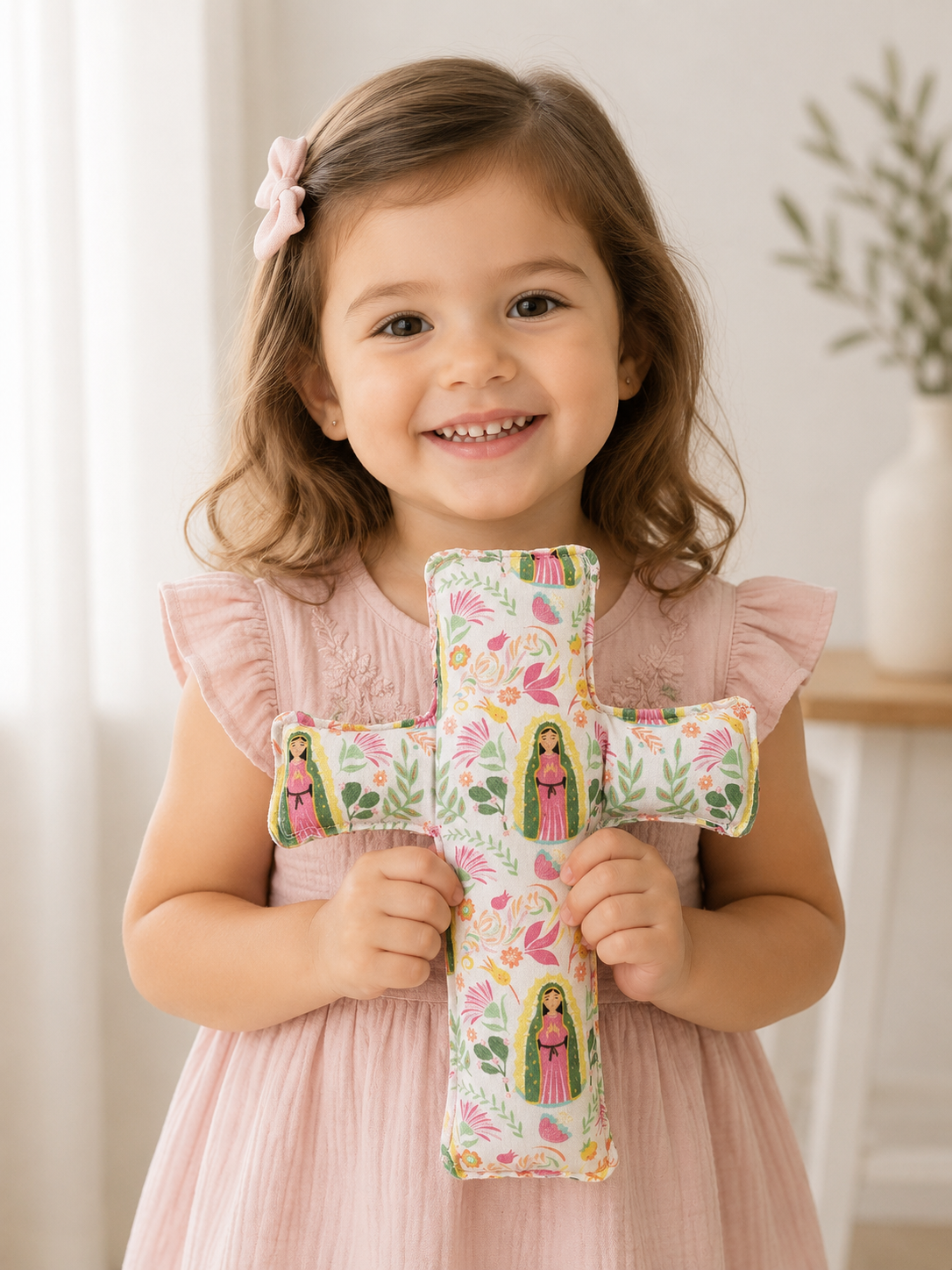 Toddler girl holding Our Lady of Guadalupe cross.png