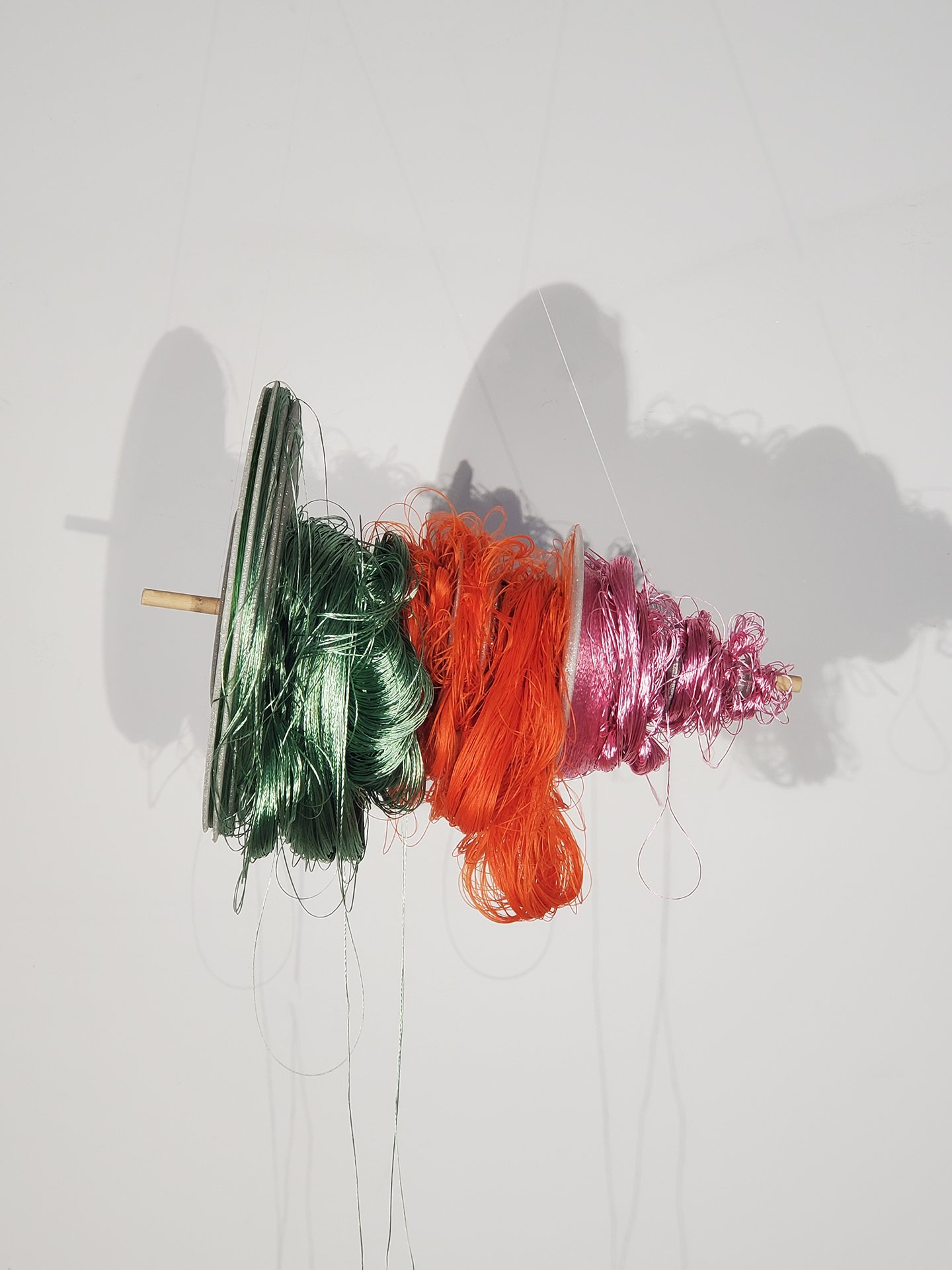 sorted or sorting - From the Library of Misheard Words. 2025. 3D printed waveform wound with rayon embroidery threads in pink, orange, and green.