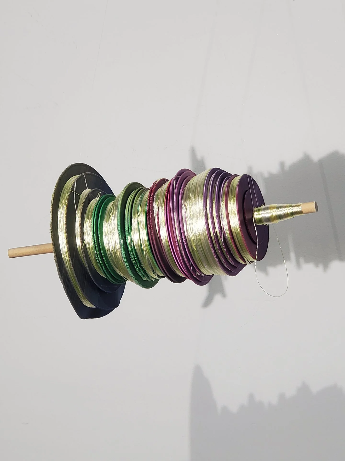 amend - From the Library of Misheard Words. 2025. 3D print of a waveform wound with rayon embroidery thread in yellow.