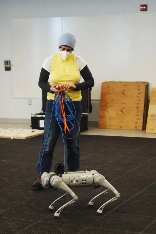 Photo of Erika Jean Lincoln/cogitechnaut with Unitree Go1 Robot Dog.