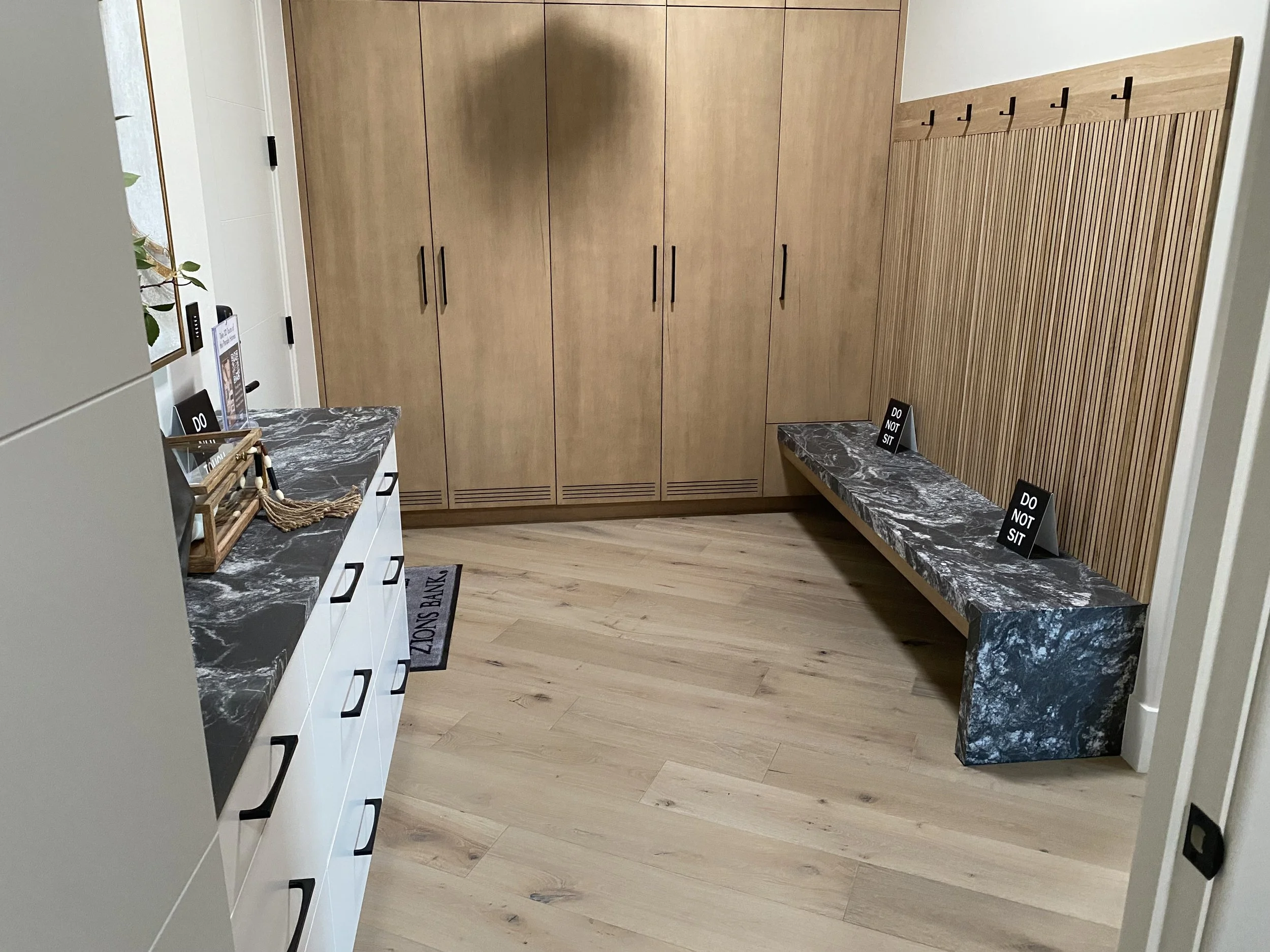 Mudroom with granite countertops and waterfall legs