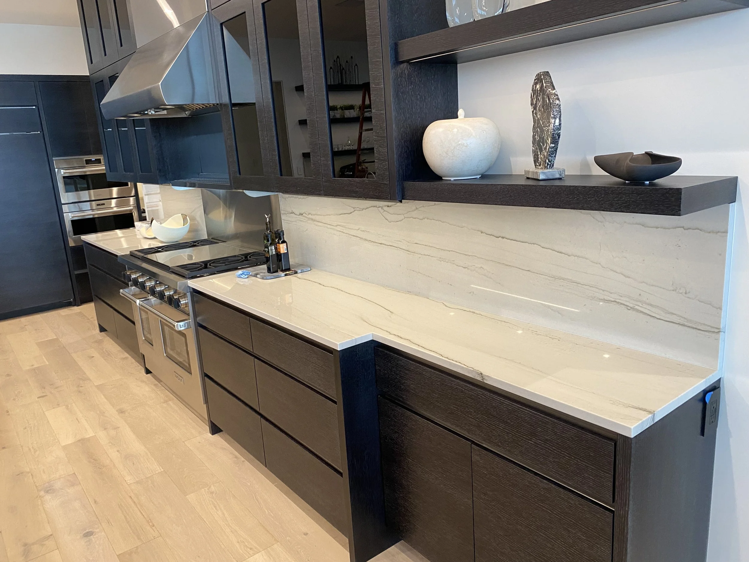 Kitchen with quartzite countertops and full height backsplash