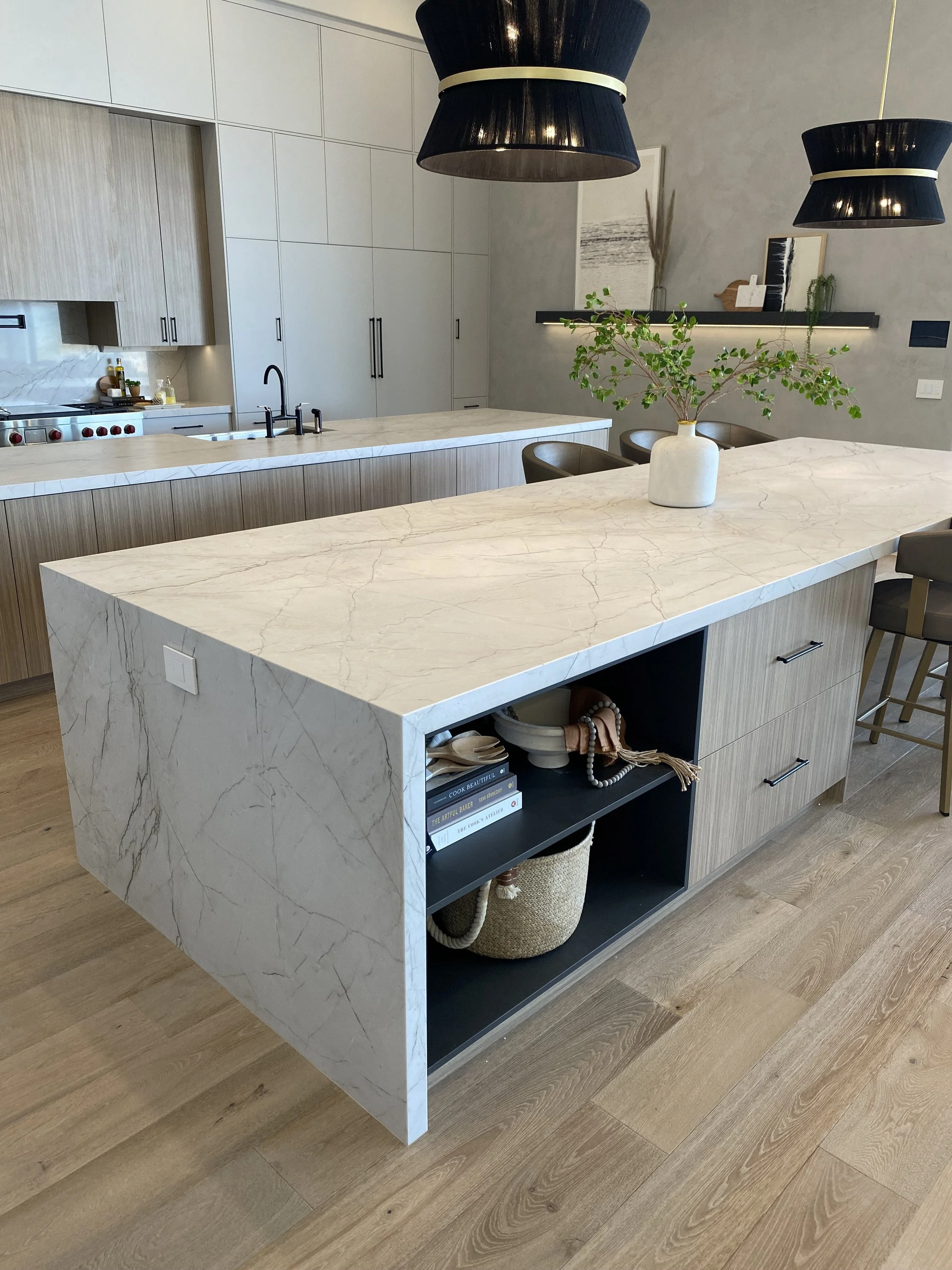 Kitchen with quartzite countertops and waterfall legs