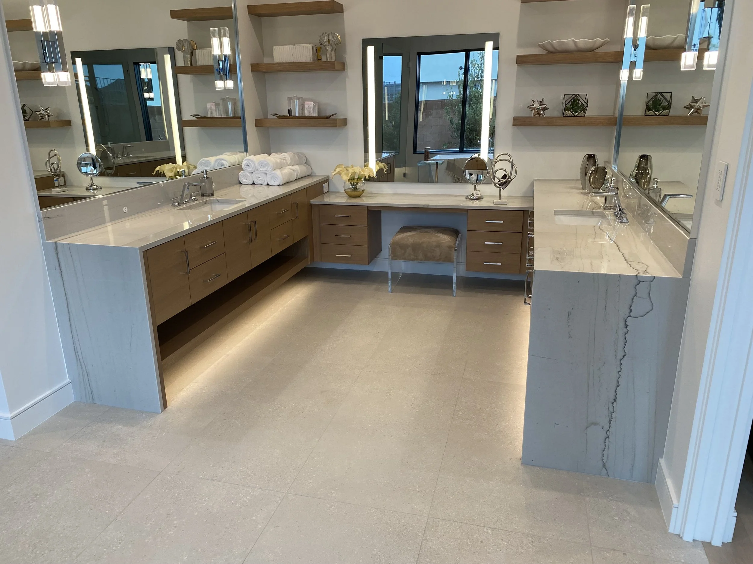Primary bath with quartzite countertops and waterfall legs