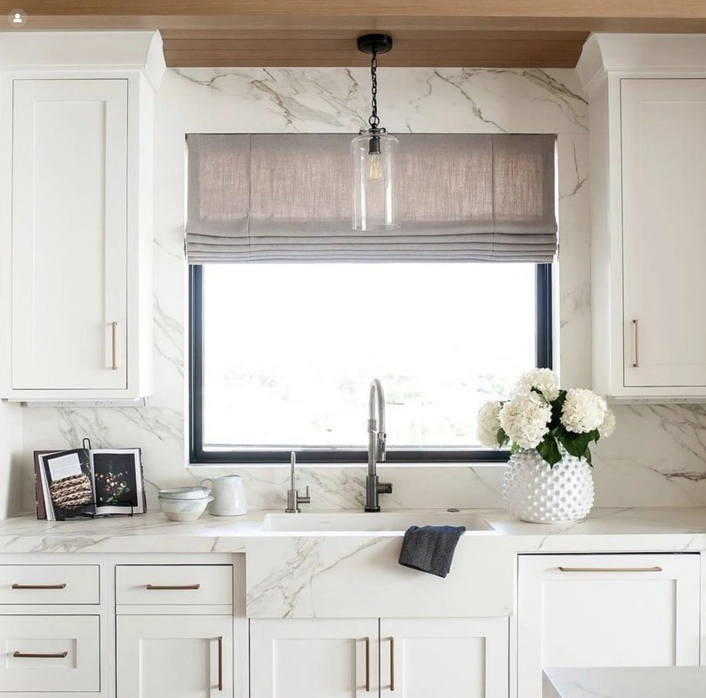 Kitchen with neolith countertops, full height backsplash and miter apron
