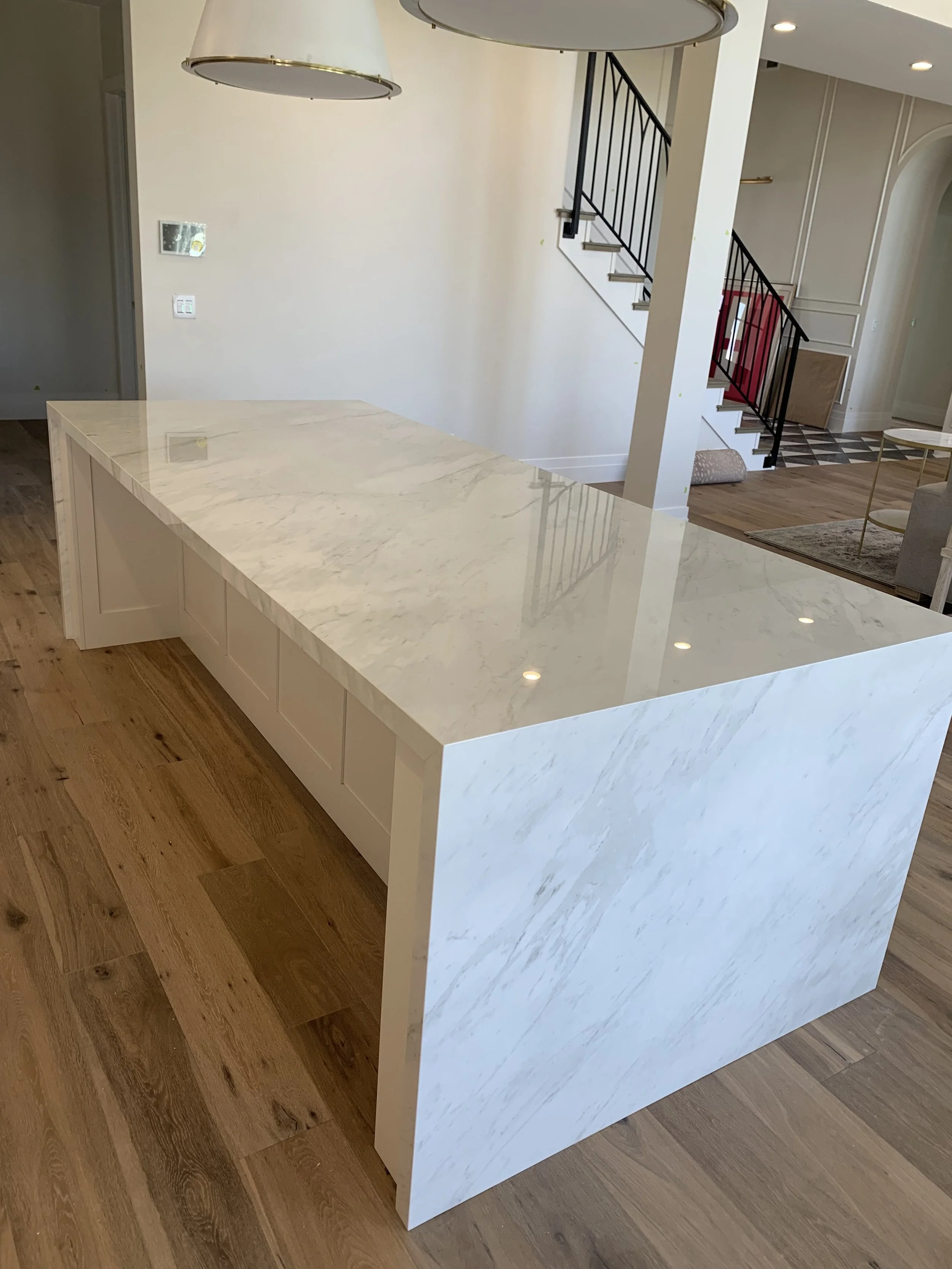 Kitchen island with neolith countertop and waterfall legs