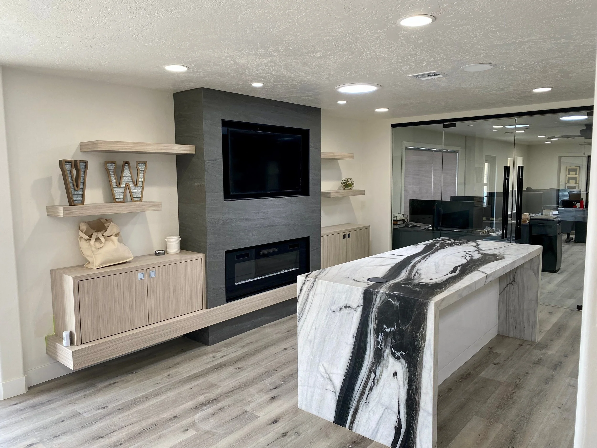 Office showroom & neolith fireplace. Quartzite island with waterfall legs