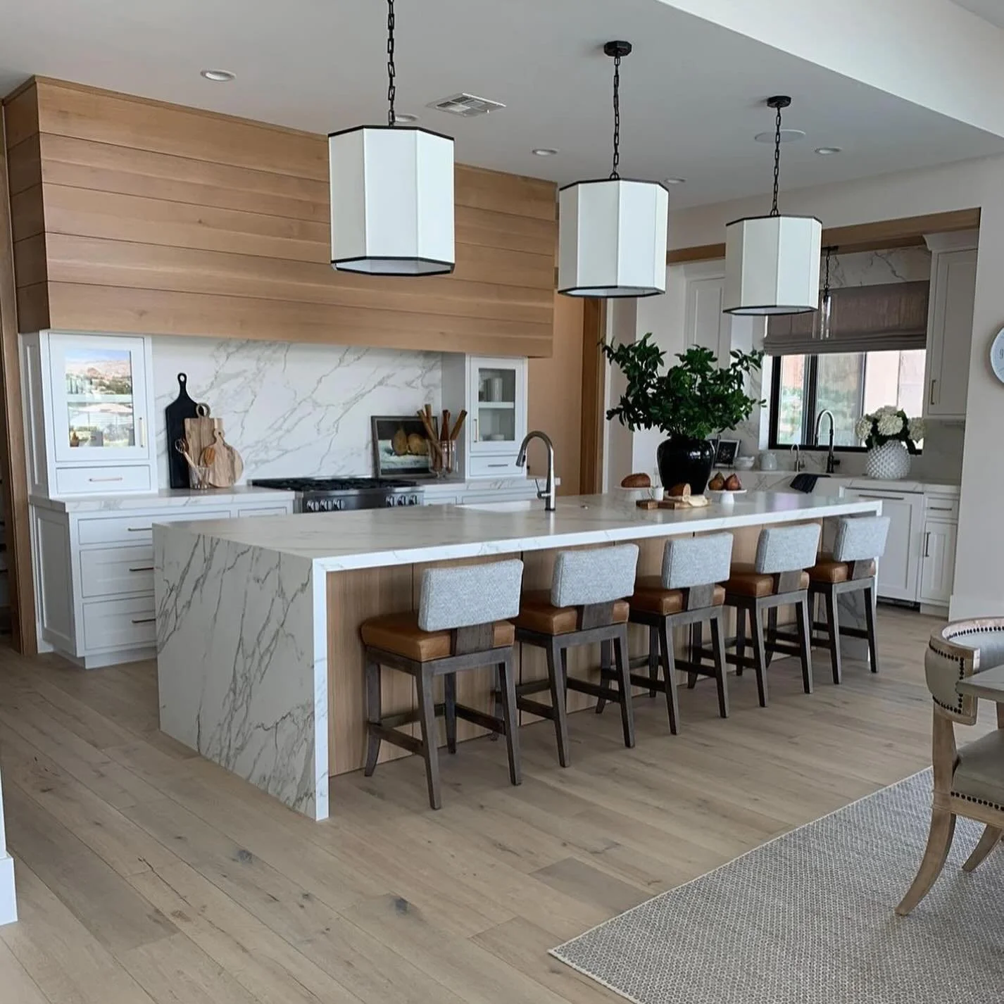 Renaissance Fabrication kitchen with 5 barstool chairs, Neolith counter tops, Neolith full backsplash and waterfall legs