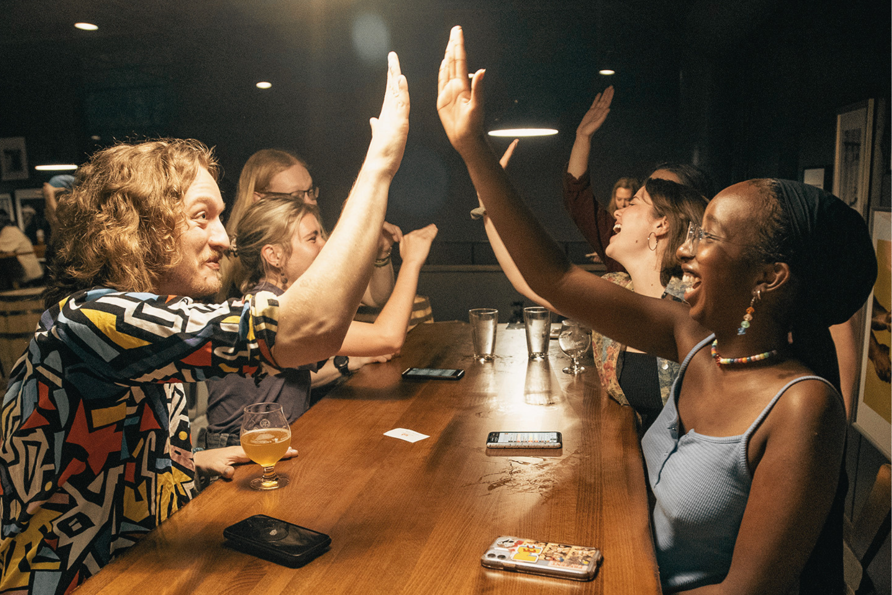 Group of friends cheerfully high-fiving each other