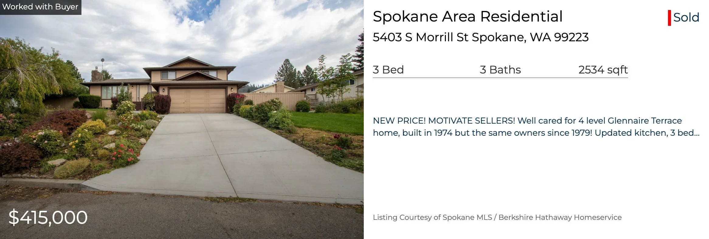 Photo of a two-story house with a front yard garden and a concrete driveway leading up to a garage, under a cloudy sky.