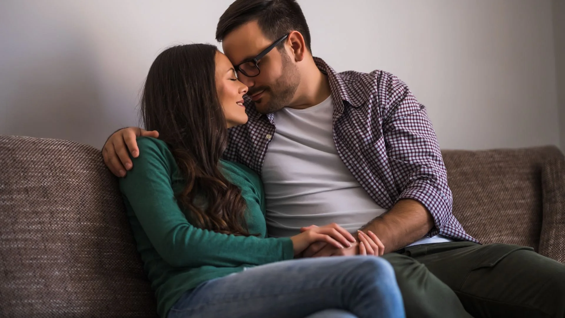 A loving couple embracing and sharing a romantic hug indoors.