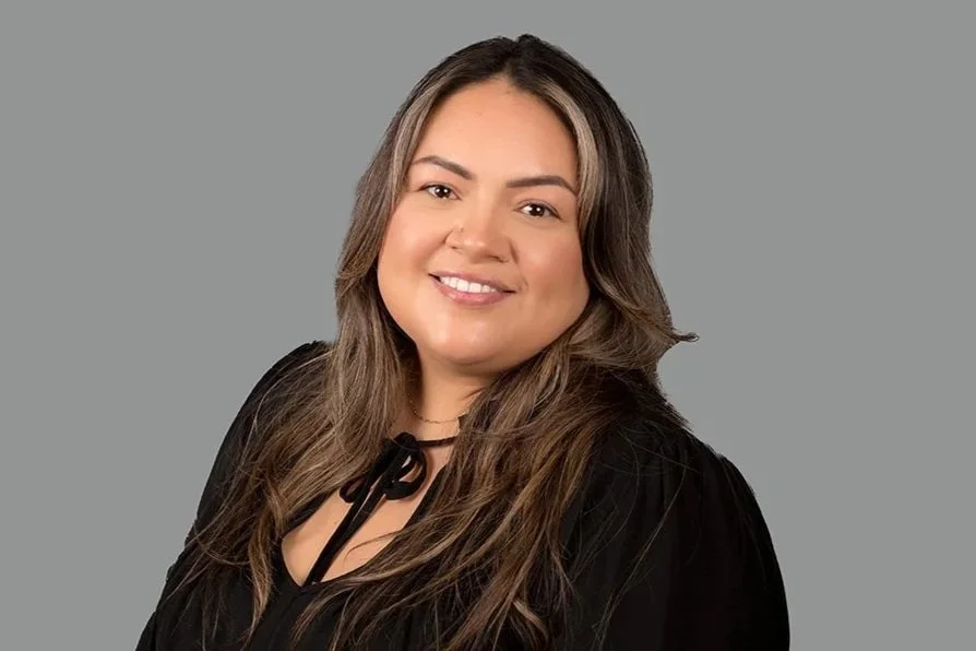 Jazmin Klassen, a professional headshot photo of Jazmin, Senior Family Law Clerk at Drake Law Family Lawyers in London, smiling, in formal attire, in front of grey background.