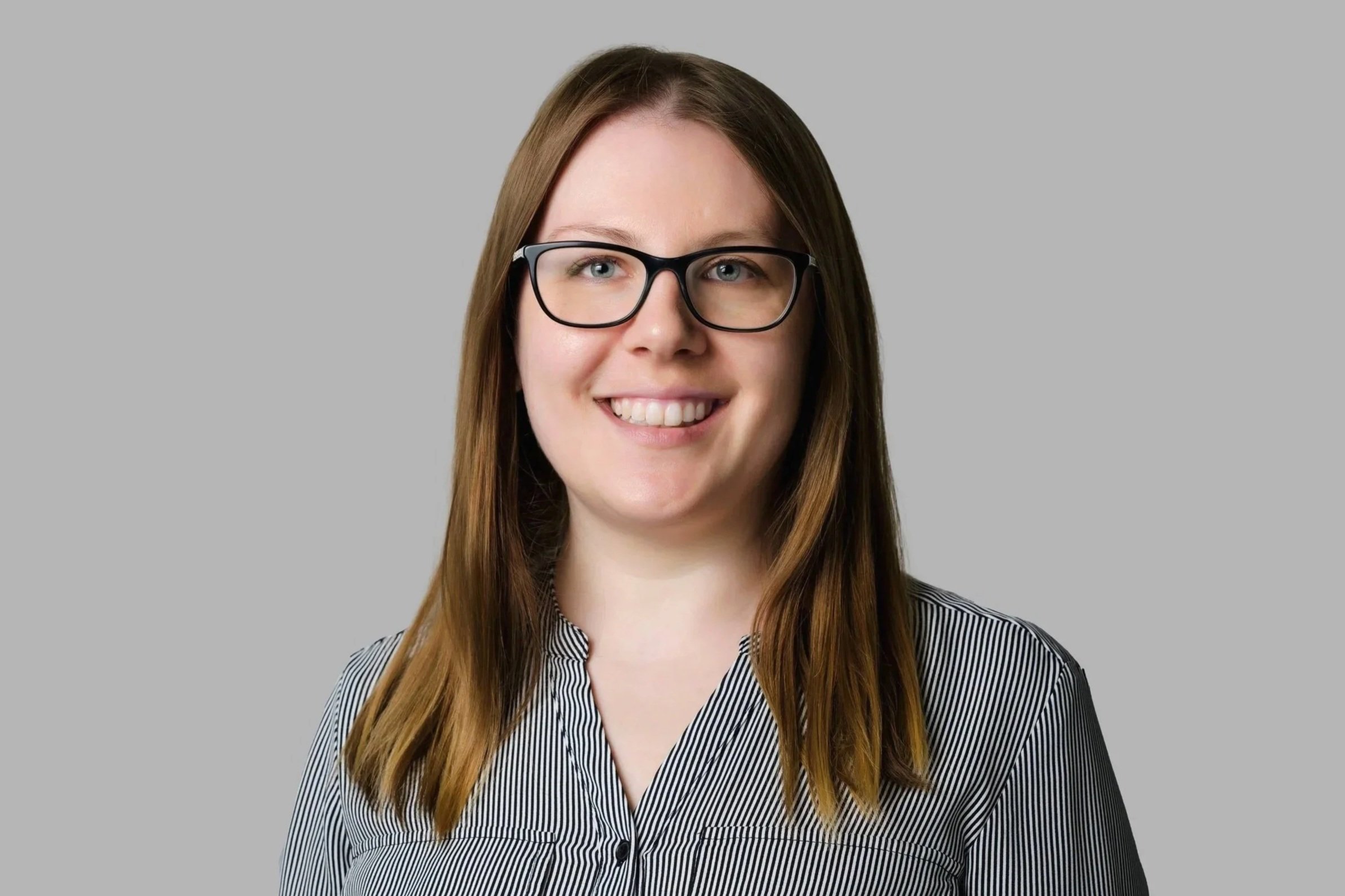 Julie Russell, Family Law Legal Assistant - A professional headshot photo of Julie smiling.