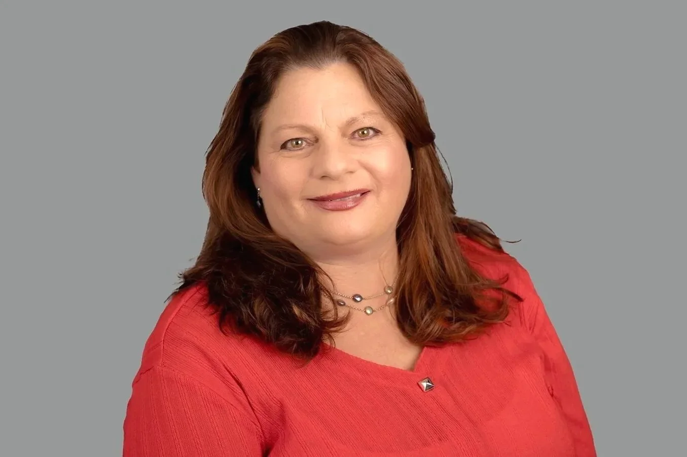 Professional headshot of Pam Golden, Senior Family Law Clerk at Drake Law, in formal attire, grey background behind her.