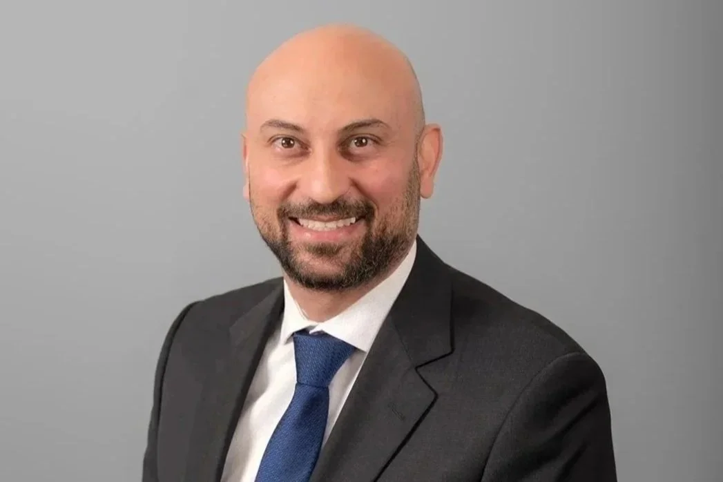 Eyad Shapp, Associate Lawyer at Drake Law - a professional portrait of Eyad in black suit, white shirt and a blue tie.