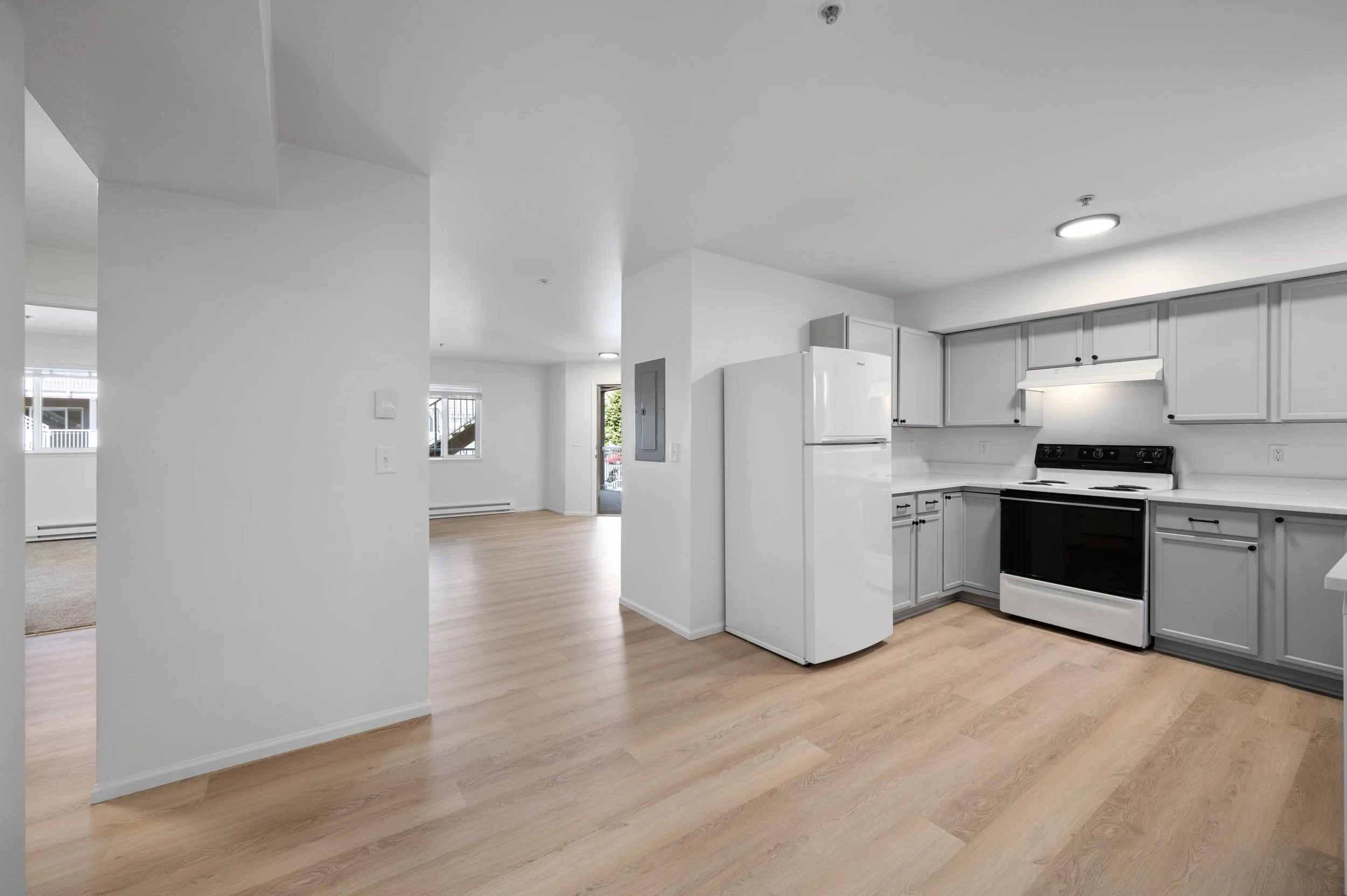 The fully remodeled kitchen, dining, and living areas in a 2-bedroom apartment at Edgemont in Bellingham, WA.