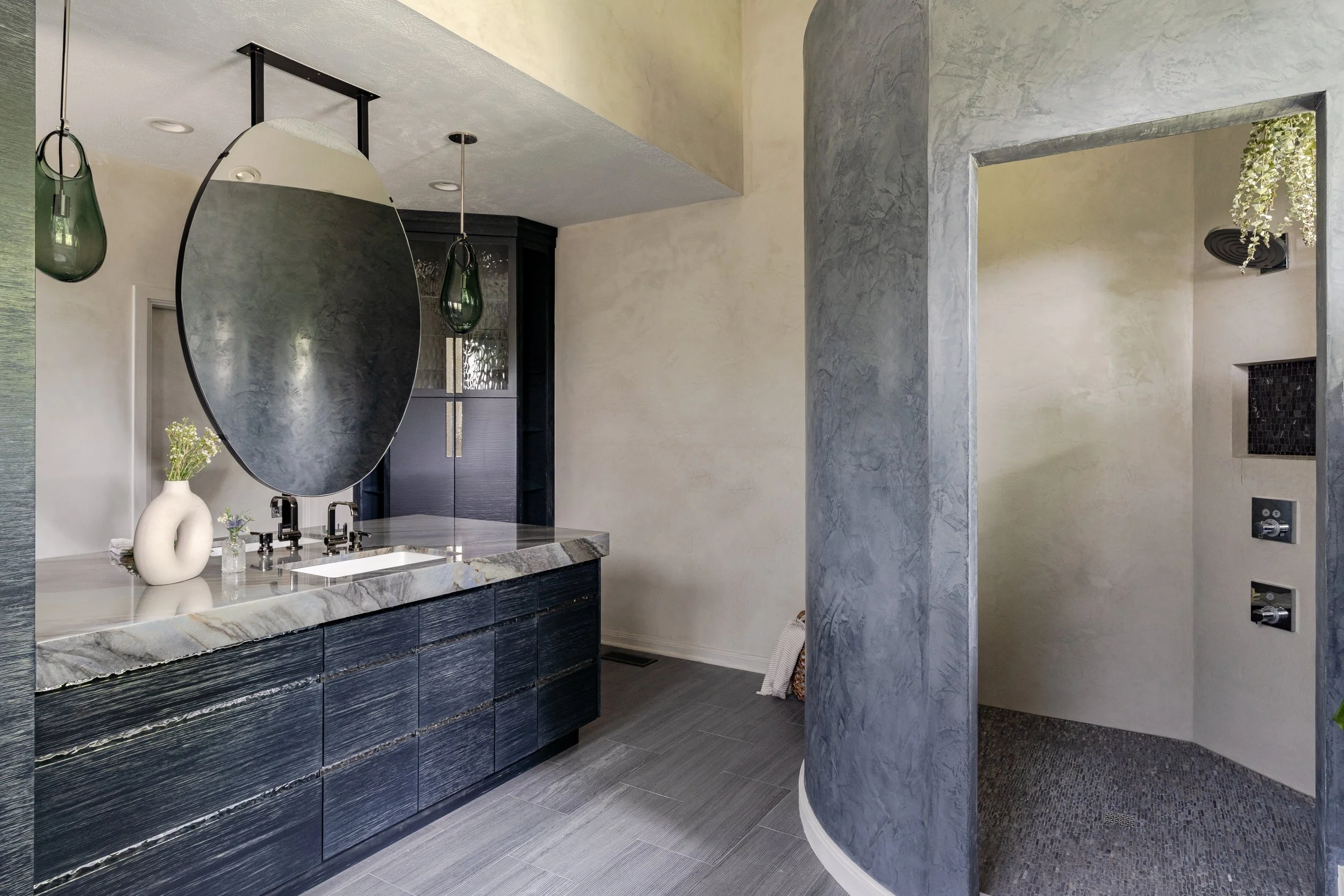 Natural stone shower floor in the Elemental Bath project.