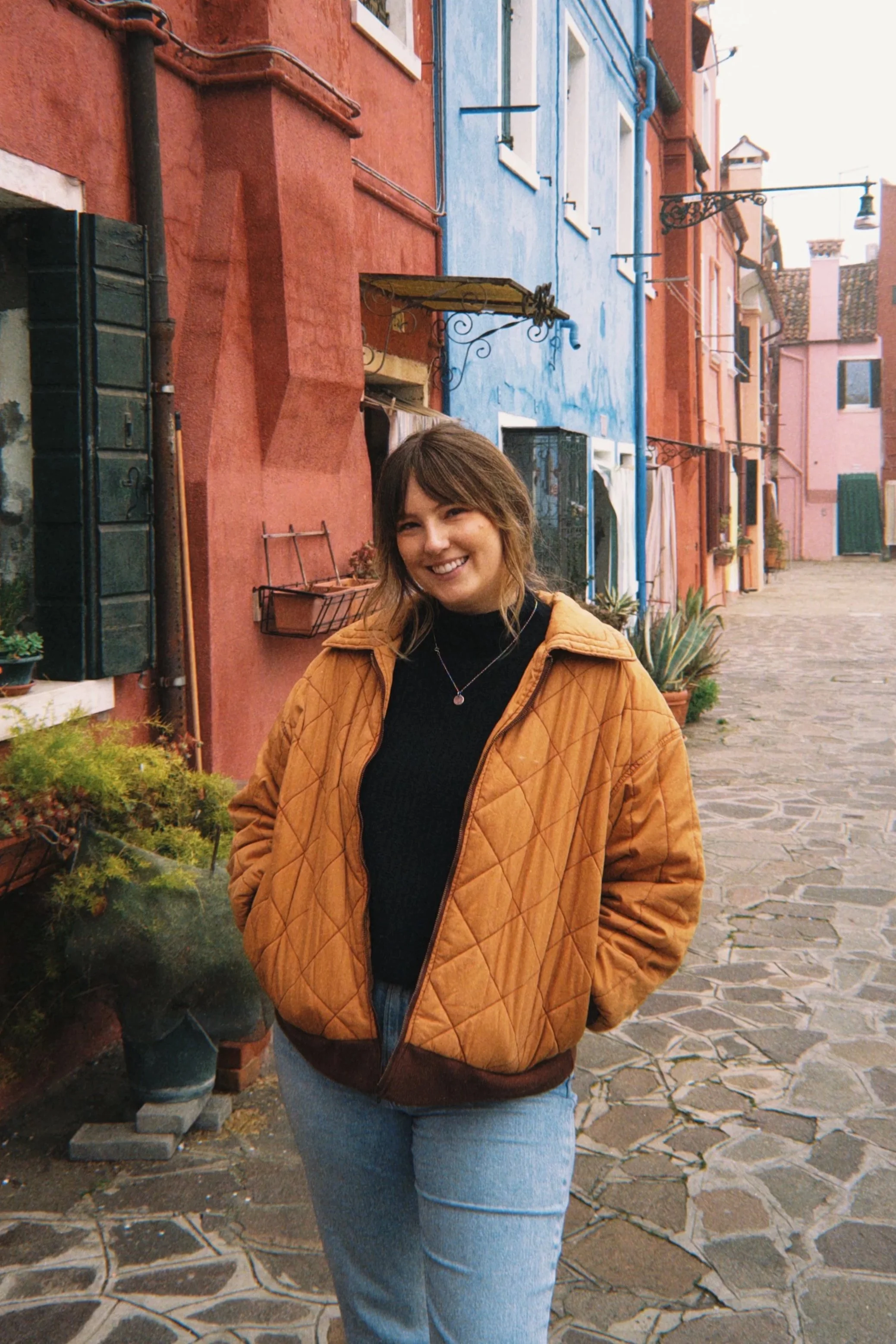Smiling woman in yellow floral dress outdoors