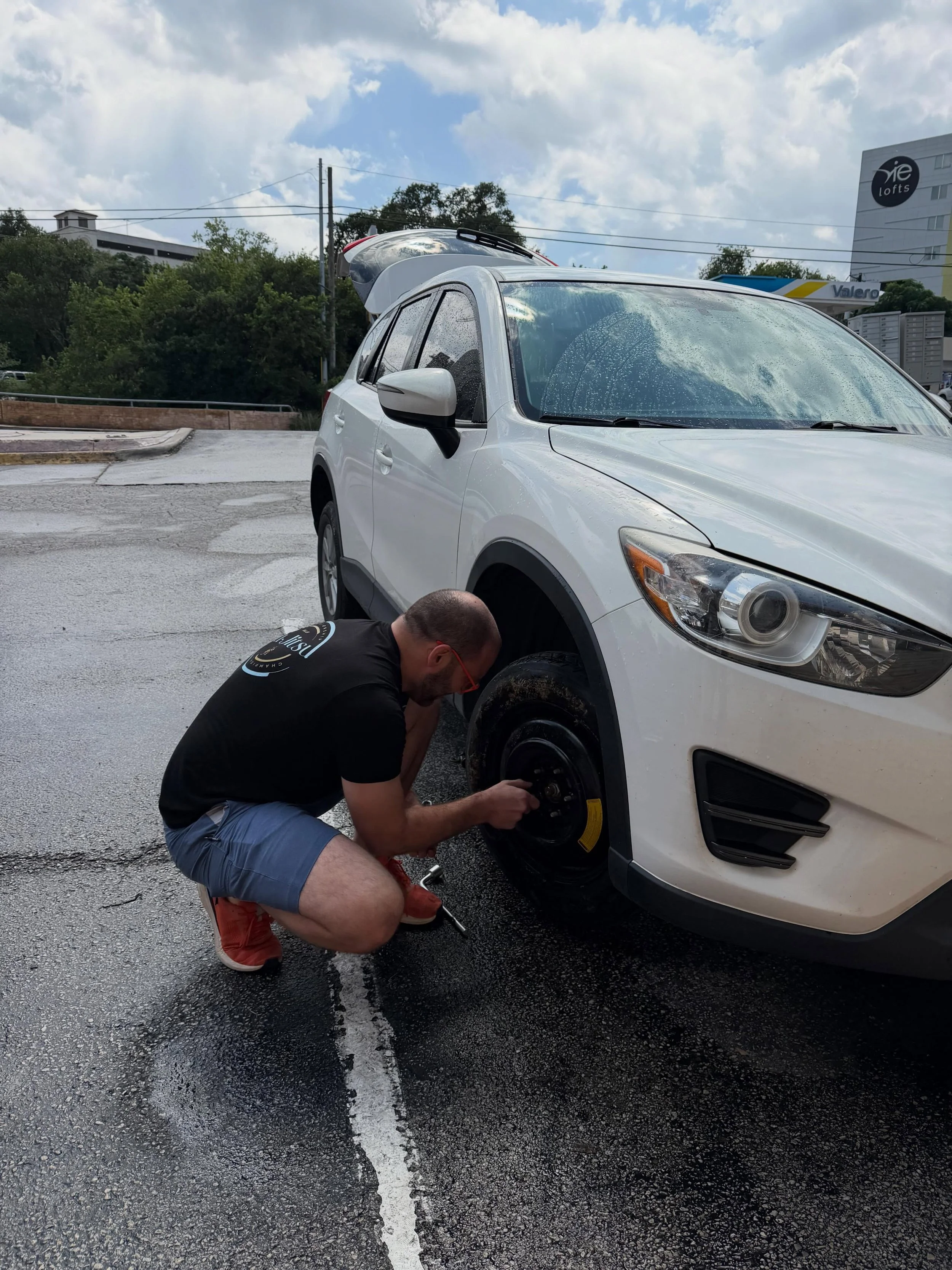 Just another day at DINO in between classes a young lady was waiting in her boyfriend to come change her flat tire (shame on her dad) but before he could even get to her a DINO team member was out there in the rain and able to change her tire in no t