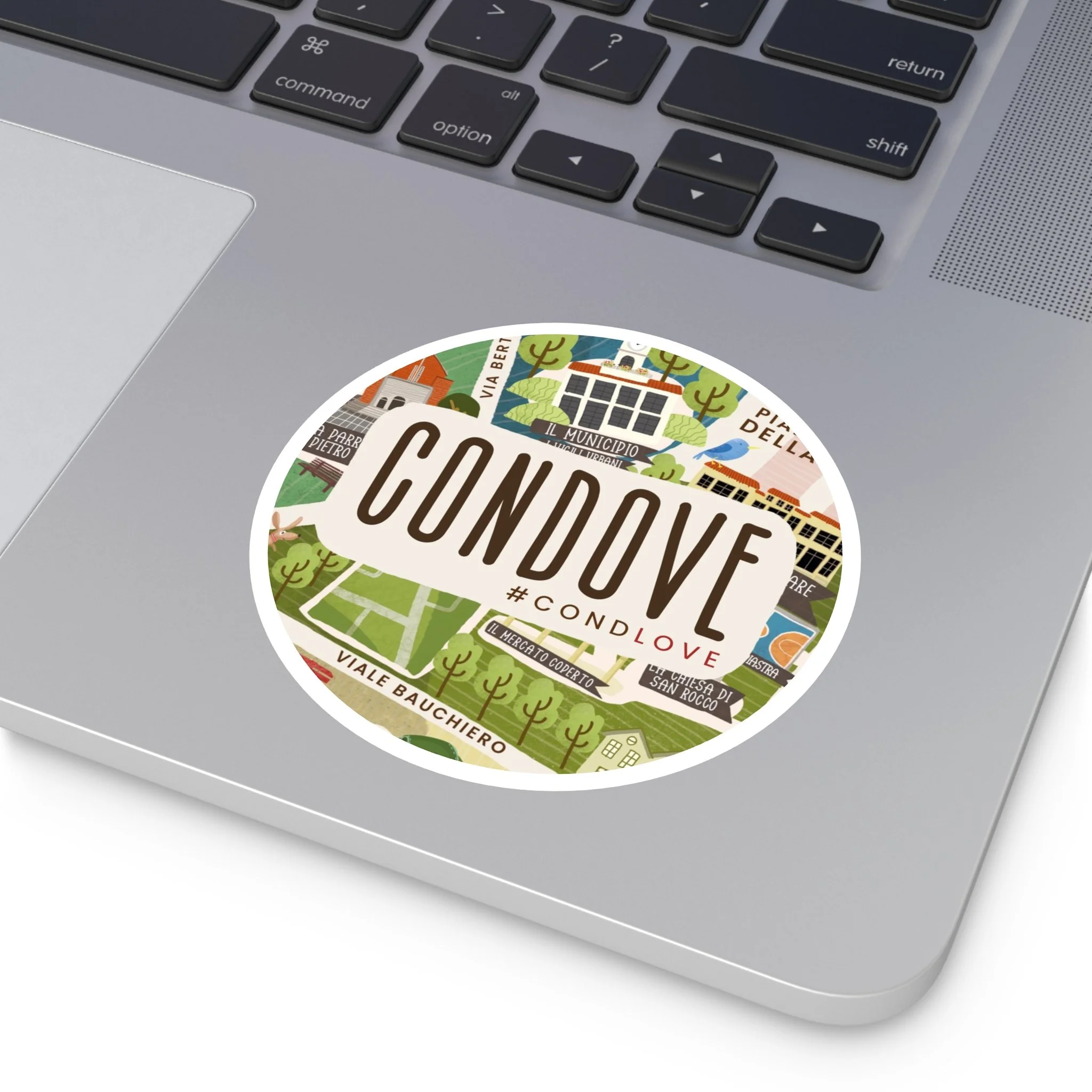 Sticker attaccato a un laptop con il testo 'CONDO' e vari indirizzi e luoghi di un quartiere.
