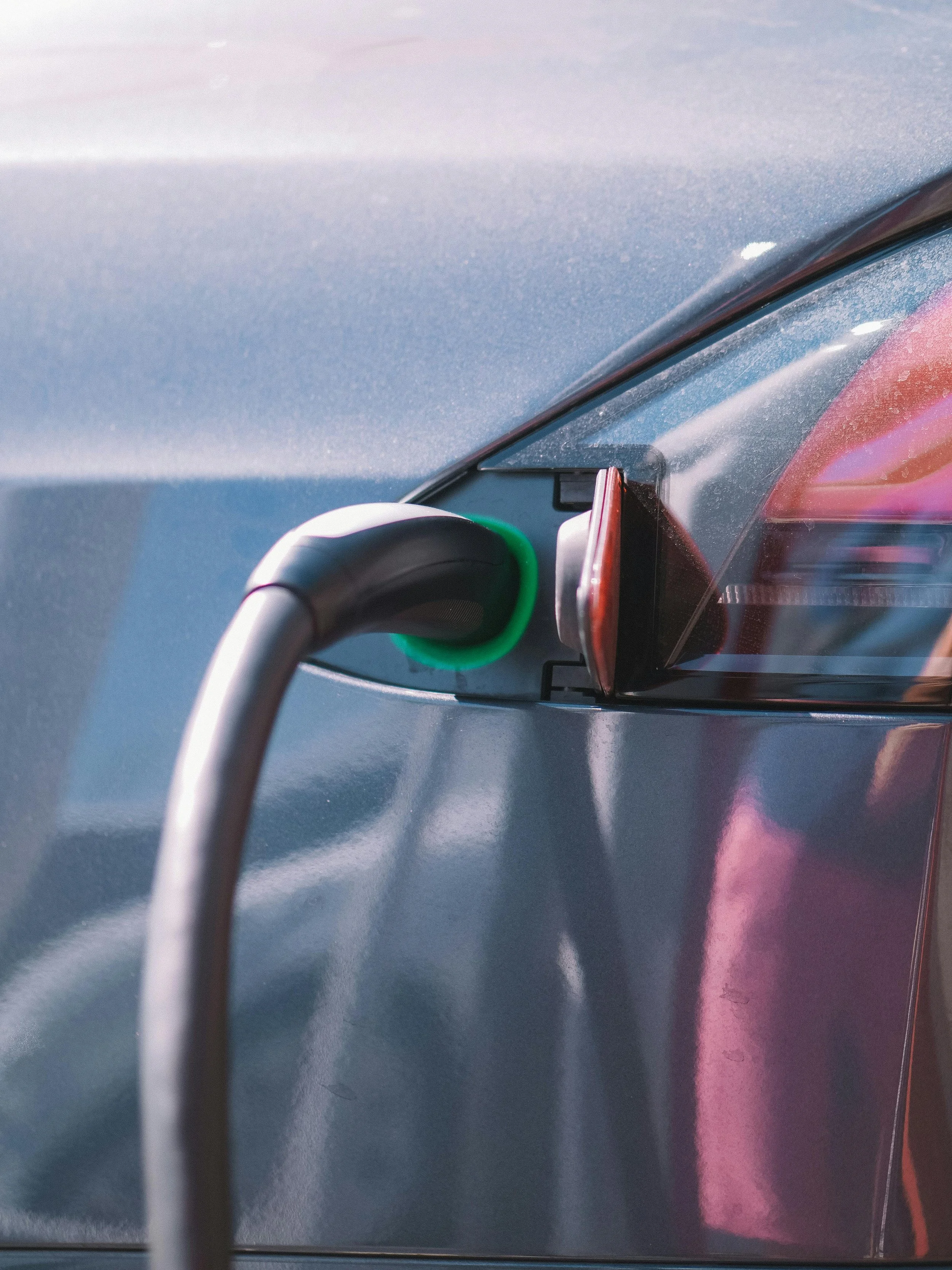 Level 2 electric vehicle charger plugged into EV at residential home