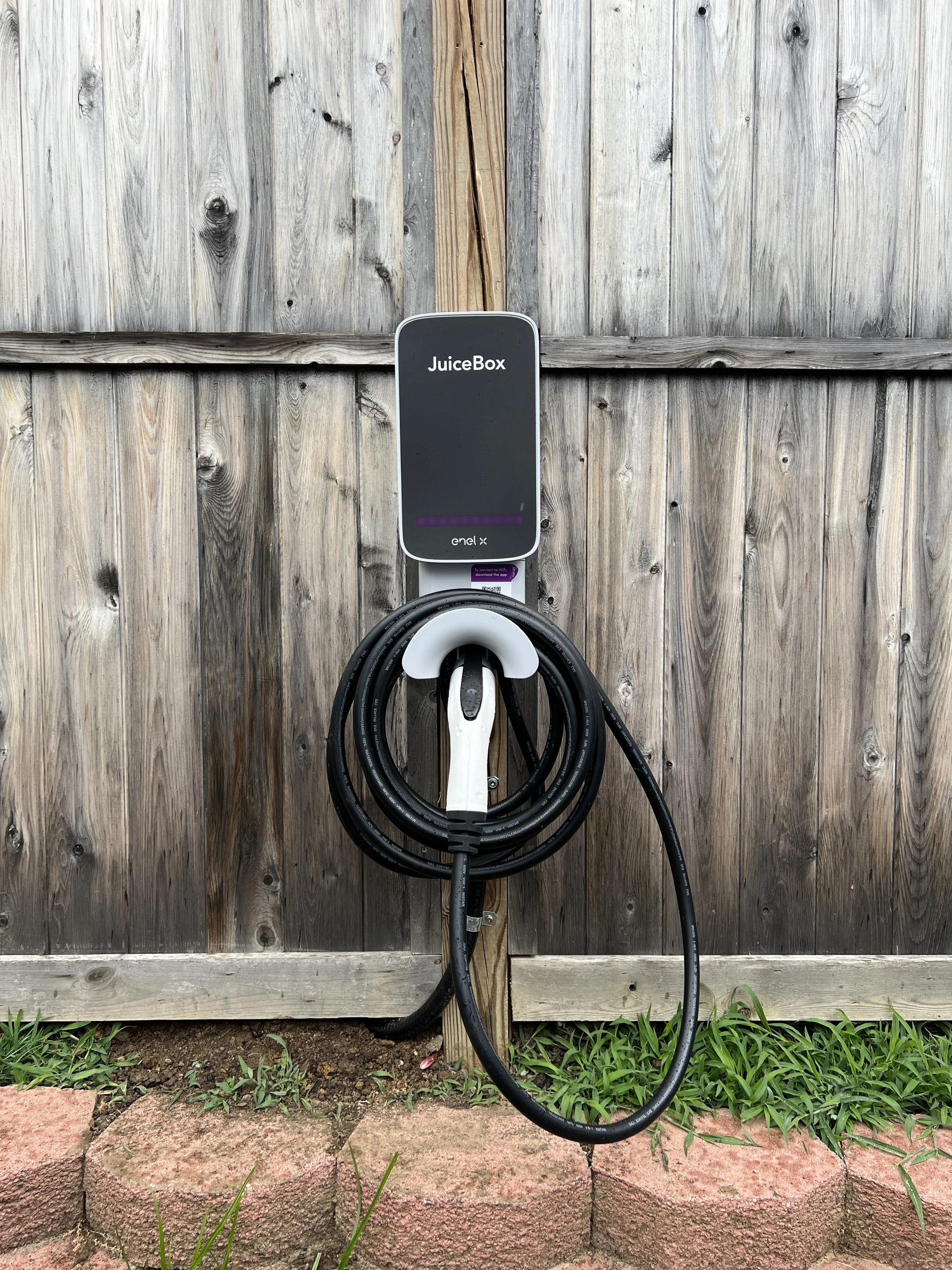 EV charger installed on garage wall by Weinstein Electric
