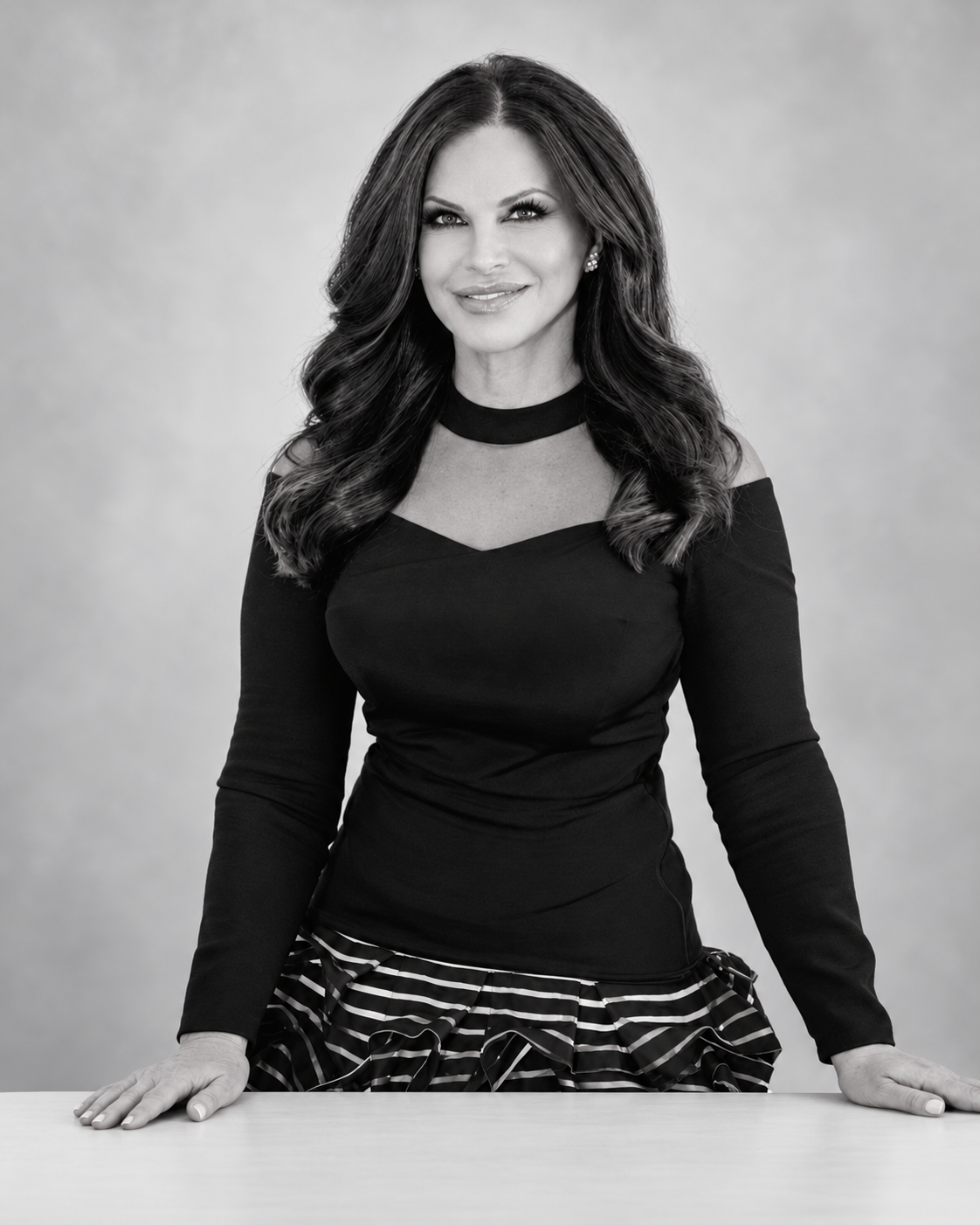 Suzi Yelvington standing behind a desk